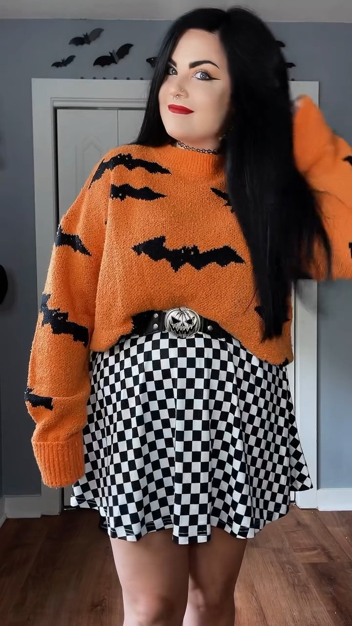Cozy Halloween look for you all today 🎃🖤
You guys I am In LOVE with this cozy super Halloween bat sweater! It’s the perfect shade of orange. 🎃🦇

My elder emo heart had to pair it with a black and white checkered skirt! 🏁
.
.
.
.
.
#pumpkinpatchoutfit #halloweensweater #batsweater #fallsweaters #falloutfits #falloutfits2024 #plussizefalloutfits #size14to16 #styleover30 #altfashion #altfashionoutfit #altootd #sweaterweather #elderemo #checkeredskirt #cozyfashion

#LTKHalloween #LTKVideo #LTKPlusSize