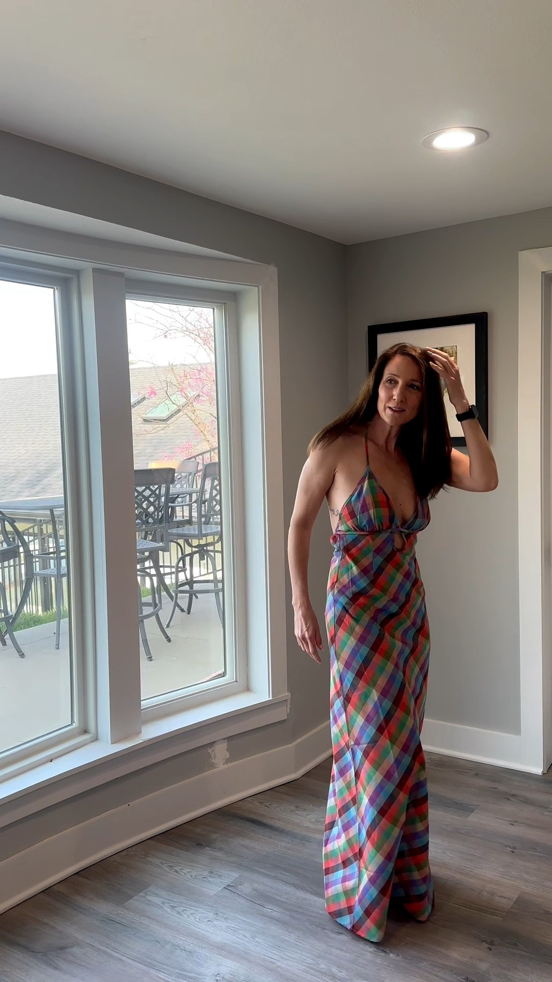 Sticking to bold patterns and flattering silhouettes for a productive afternoon in the sun. 🎀🌟 This halter-neck plaid dress is my secret to looking completely put-together with minimal effort. Check out the link in my bio to shop this look and refresh your own getaway rotation! 🌟 #StyleInspo #PlaidDress #EffortlessChic #ShopMyLook

My Plaid Panache Style Breakdown
• The Dress: I’m wearing a floor-length halter-neck maxi dress featuring a vibrant, multi-colored plaid print in shades of blue, green, orange, and purple.
• The Design: The dress features a deep V-neckline with a unique circular ring detail at the center of the bust and thin halter straps.
• The Accessories: I’ve kept the look clean and focused on the dress, styling it with my everyday black fitness tracker.
• The Vibe: This outfit is the definition of "resort glam"—it’s a fresh, colorful take on a classic motif that's perfect for a vacation evening.
• The Setting: I am showcasing this look at my home at Weatherby Lake, MO.

multi-colored plaid dress, halter maxi dress, plaid maxi dress, ring detail dress, colorful resort wear, vacation maxi, summer plaid style, sleeveless maxi dress, effortless vacation outfit, bold pattern dress, @VICI 

#LTKdayinmylife #LTKootd #LTKOver40