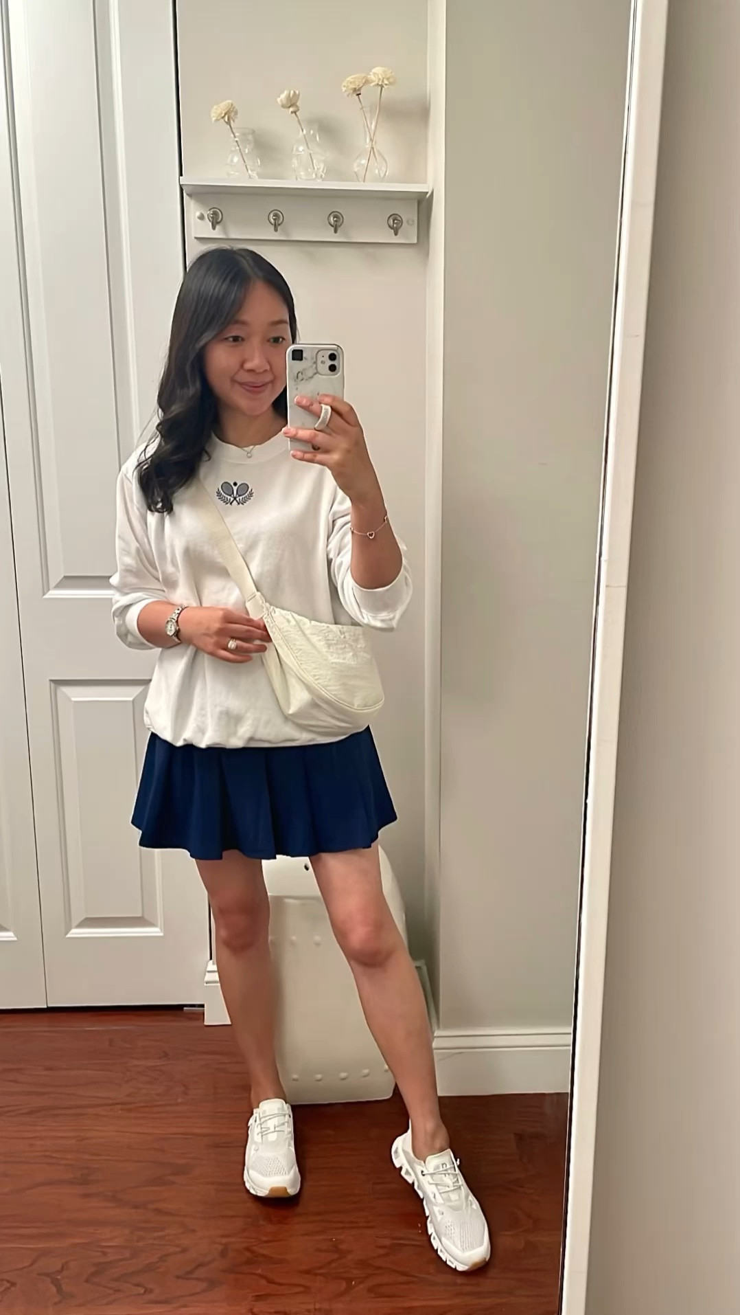 This Old Navy oversized tennis sweatshirt is so cute! It says 'Leisure Club' in the back. I was stalking it for weeks until XS petite popped back although it's still very big. I wish they offered size XXS petite.

Pleated navy skort in size XS

Uniqlo crossbody bag available in more colors.

#LTKFindsUnder50 #LTKOver40 #LTKSaleAlert