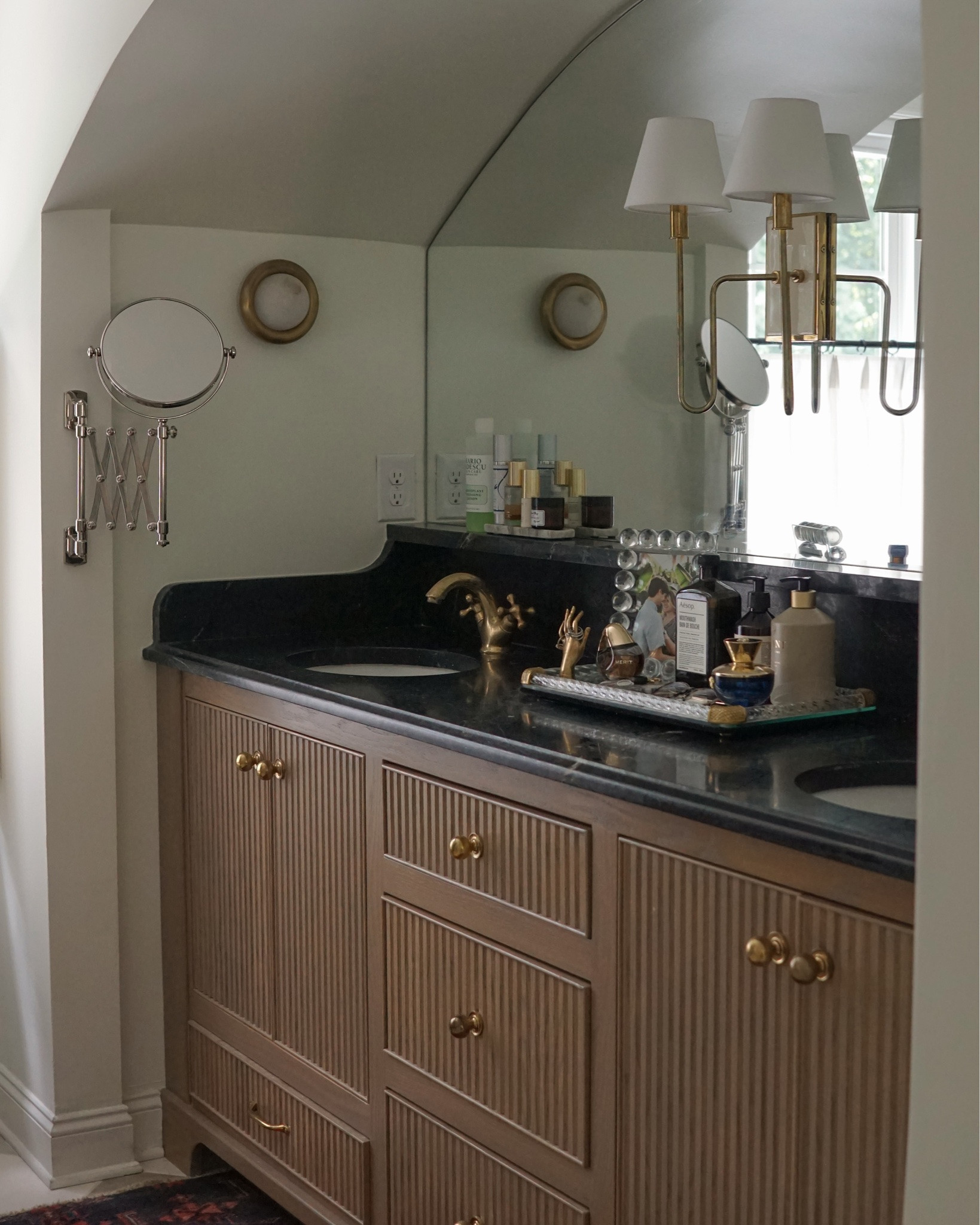 Our arched vanity alcove is still one my favorite details from our Tudor renovation. This spot used to be two small closets, but I think it was always meant to be this 🥹

File this Aesop mouthwash under things I absolutely did not need but am obsessed with 😆

I bought this mouthwash months ago (admittedly because I couldn’t stand to look at the grocery store brand bottle for one more minute 😂) and while the actual Aesop product is long gone, the glass bottle has been PERFECT for refilling with our regular brand. Highly recommend if you want a one time mouthwash splurge (~$30) that comes with a pretty, reusable bottle. 

Also obsessed with this lotion from @soinscolomba and wishing I could hop on a flight to Paris right now to buy more 🥲

We stayed at @hotelrochechouart when we were in Paris back in May and our room was stocked with all of the Soins Colomba products. I fell in love with the scent and came back with a candle, shampoo, lotion, and soap, which are all just about empty now (🥲). This line is exclusive to @orsohotels and you can only buy it in France at one of their properties… so if you’re lucky enough to stay at one of their hotels, stock up, because I am now having withdrawals 😆