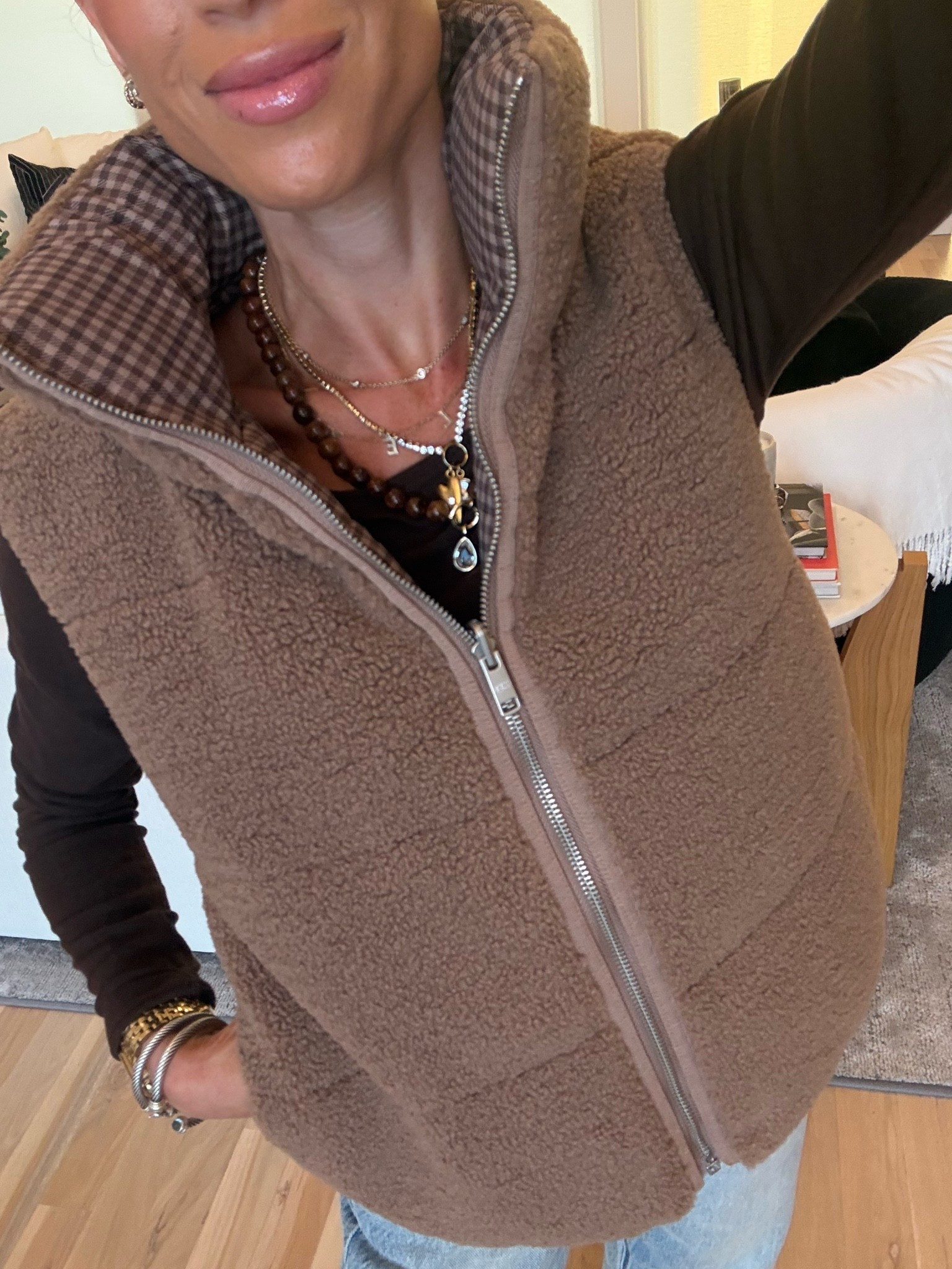 Cutest reversible Sherpa vest with plaid on one side Sherpa on the other wearing xxs