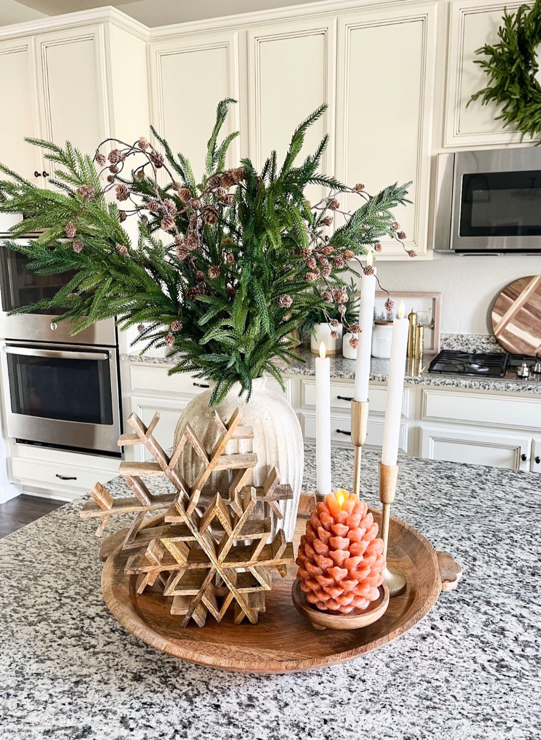 Sharing my early winter / Christmas tray styling. This will be perfect for a kitchen counter or centerpiece!  Follow @lifeinmyarizonahome on Instagram for more holiday ideas and inspiration. 

For reference I’m using 4 of the Norfolk stems and 4 of the pinecone stems. 

Round wood tray | gold candlesticks | flameless taper candles | wood snowflakes | Weathered Handcrafted Terracotta Vase | snowy pinecone stem | Luminara Pinecone Flameless Candle | Small Wooden Riser Wooden Pedestal  

#holidaydecor #winterdecor #traystyling #christmasdecor



#LTKHome #LTKHoliday #LTKSeasonal