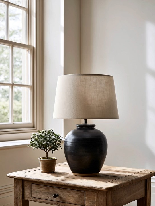 Lighting is the foundation of every beautiful home.

It's not just about seeing the room. It's about how the room makes you feel.

One of the biggest mistakes we see is relying only on harsh overhead lighting. It flattens the space, creates harsh shadows, and even takes away from the beautiful view outside your windows.

That's why we love layered lighting.

And the easiest place to start? An oversized table lamp.

A sculptural black base paired with a timeless ivory shade is one of those combinations that works in every style of home, from modern to traditional, minimalist to classic. During the day, it stands beautifully as a decorative piece. In the evening, it fills the room with warmth, softness, and atmosphere.

If you're styling a bedroom, we always recommend a matching pair on both sides of the bed for balance and symmetry. In a living room, one oversized lamp on a console table, side table, or entryway instantly creates a designer finish.

We've curated multiple oversized black and ivory table lamps to help you create a home that feels warm, elegant, and beautifully layered.

Because beautiful lighting doesn't just illuminate a room. It transforms it.

#LayeredLighting #TableLamp #HomeDecor #InteriorDesign 

 #LTKHome