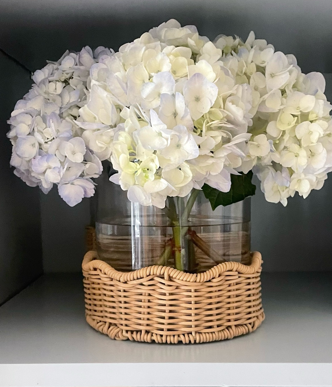 Obsessed with this chic little detail! This vase brings the perfect touch of natural texture with its rattan scalloped base — such an easy way to elevate a shelf, coffee table, or countertop. Styling it with fresh blooms or dried stems makes it feel like spring year-round!

#HomeDecor #VaseStyling #RattanDecor #NeutralHome #ScallopedEdge #ShelfieStyle #LTKhome #LTKfinds #OrganicModern #InteriorInspo