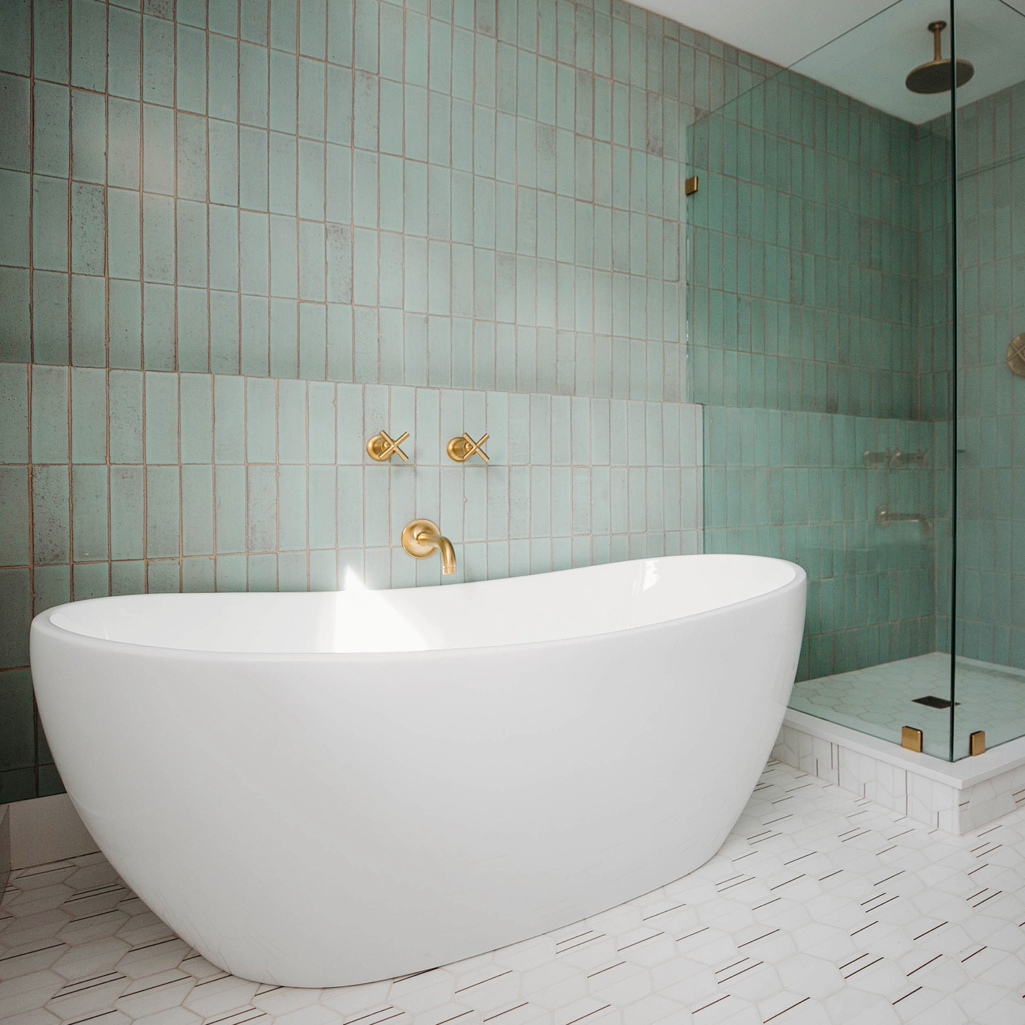 our goal with the guest bathroom at this mid-century modern fixer-upper was to create a spa-like experience at home. #dwelloctoberstudio removed a defunct laundry chute in order to maximize space and accommodate both a free-standing tub and walk-in shower. hand-glazed green brick tile makes a stunning statement on the wet walls, while marble hexagon tile with brass inlays offers a subtle contrast on the floors. stay tuned for a look at the other half of this bathroom to see the vanity. #dwelloctoberrealestate #dwelloctober 

#LTKHome
