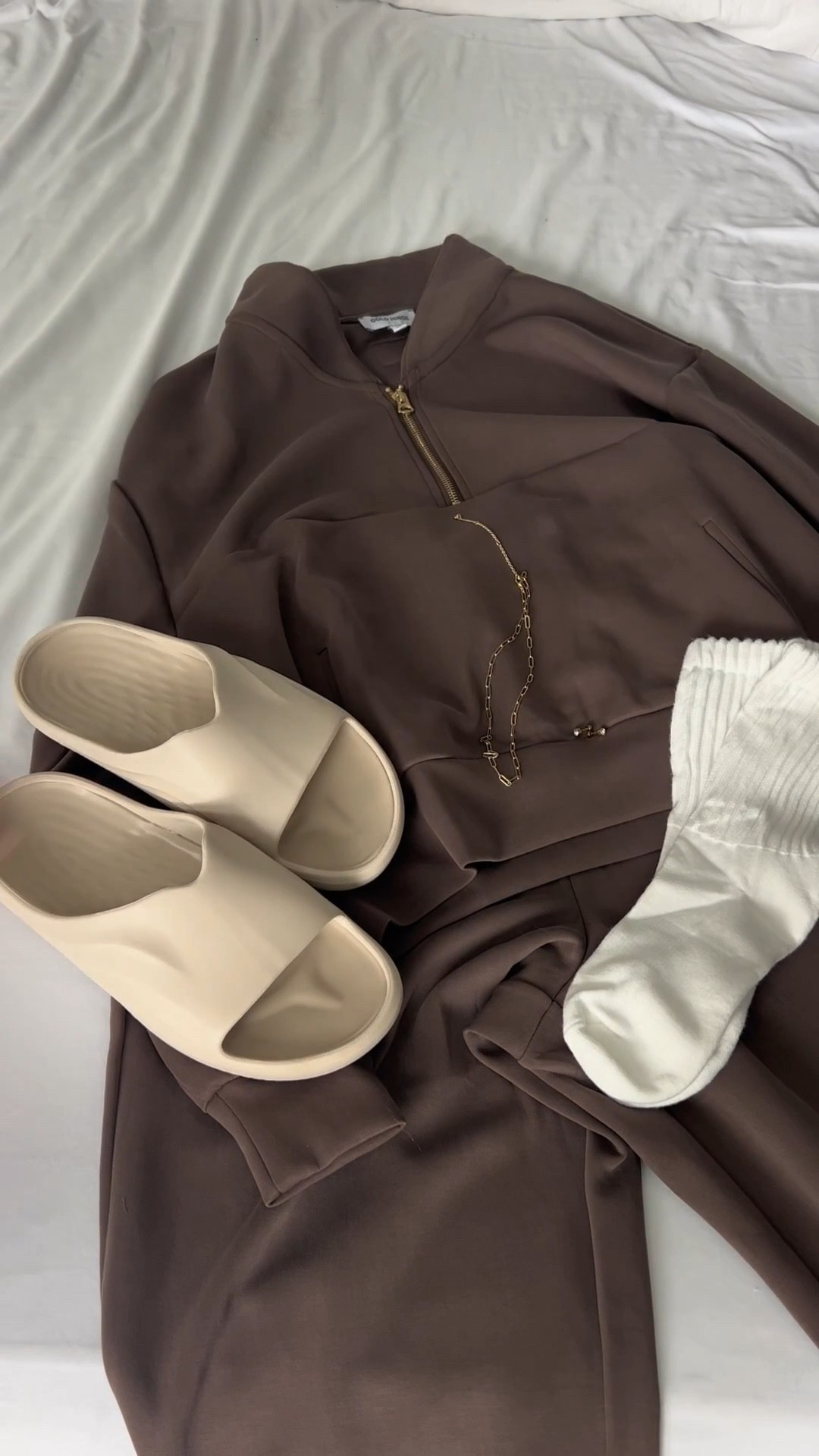 Chocolate browns and creamy neutrals just feel so cozy 🧦🤎

This set is one of those easy outfits that looks put together but feels like loungewear. The soft half zip, comfy bottoms, chunky socks, and neutral slides are basically my go to combo for slow mornings, coffee runs, errands, travel days, or just resetting at home 🏠

Add a little gold jewelry and suddenly the comfiest outfit still feels styled 💅🏻

Everything about this look is effortless, soft, and wearable all day long 🥰

#athleisurestyle #cozyoutfits #everydaystyle #neutraloutfit #comfystyle #loungeset #athleisurewear #casualstyle #softstyle #cozyvibes #errandoutfit #traveloutfit #ltkstyle #outfitinspo #neutralvibes 