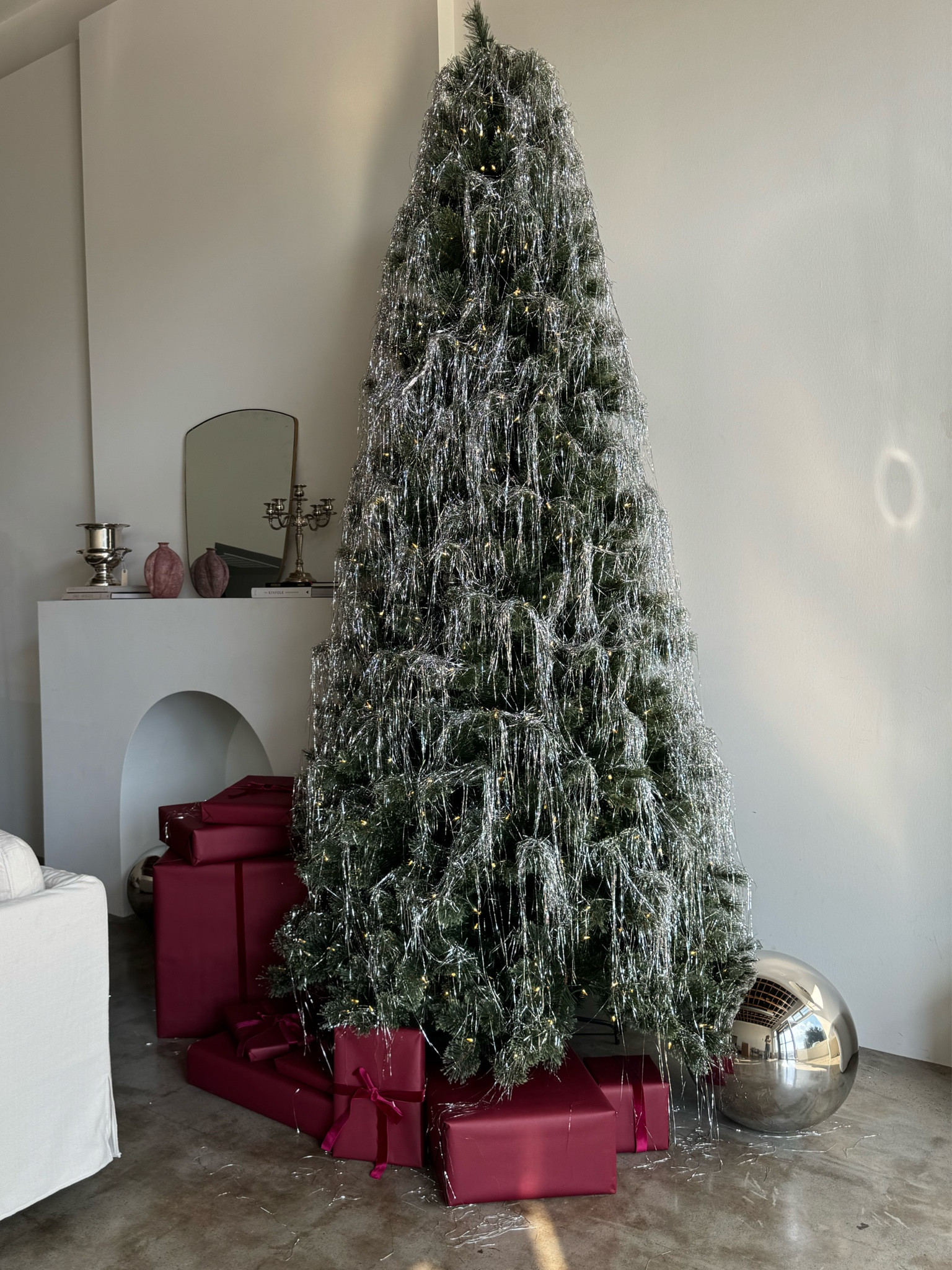 Christmas Decor: 9ft pre lit Christmas tree, tinsel, metallic silver xl Christmas ball, matte burgundy wrapping paper 

#LTKHoliday #LTKStyleTip #LTKHome