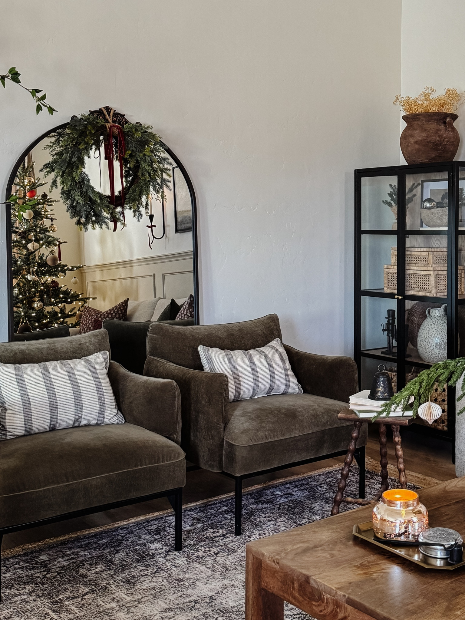 Living room inspo, Penn chairs, olive green accent chairs, custom curtains, pinch pleat curtains, floor to ceiling curtains, neutral sofa, beige sofa, west elm penn chair, green accent chair, vintage pillows, Turkish pillows, boucle pillow, shady lady tree, faux tree, greenery, Walmart floor lamp, rattan floor lamp, round coffee table, wall sconce, tapered candle holder, leather sofa, shady lady tree, loloi Sinclair rug, throw pillows, floor length mirror, arch mirror, Target home decor, affordable home, black cabinet, studio McGee cabinet, round glass coffee table, target accent table, Sinclair loloi rug, vintage inspired rug, vintage milking stool, foot stool, arch mirrorr

#LTKsalealert #LTKstyletip #LTKhome