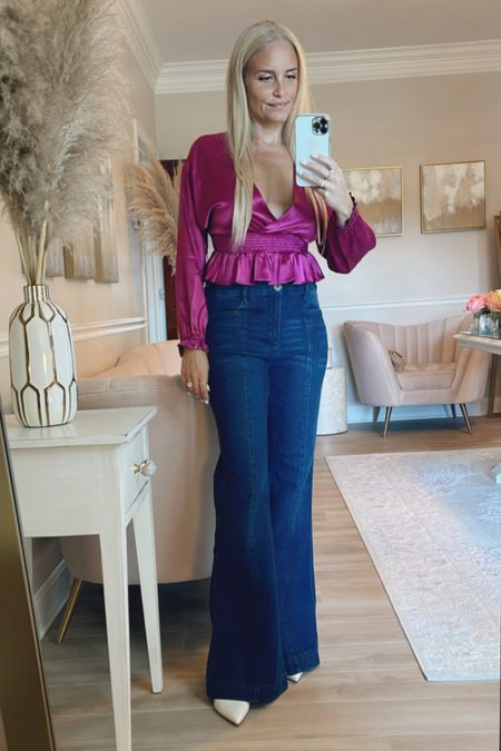 This beautiful purple satin peplum top is so silky and flattering. It's also on sale today and runs true to size. Loving these adorable flare jeans too. If between sizes, size down in the jeans. 

#LTKstyletip #LTKSeasonal #LTKsalealert