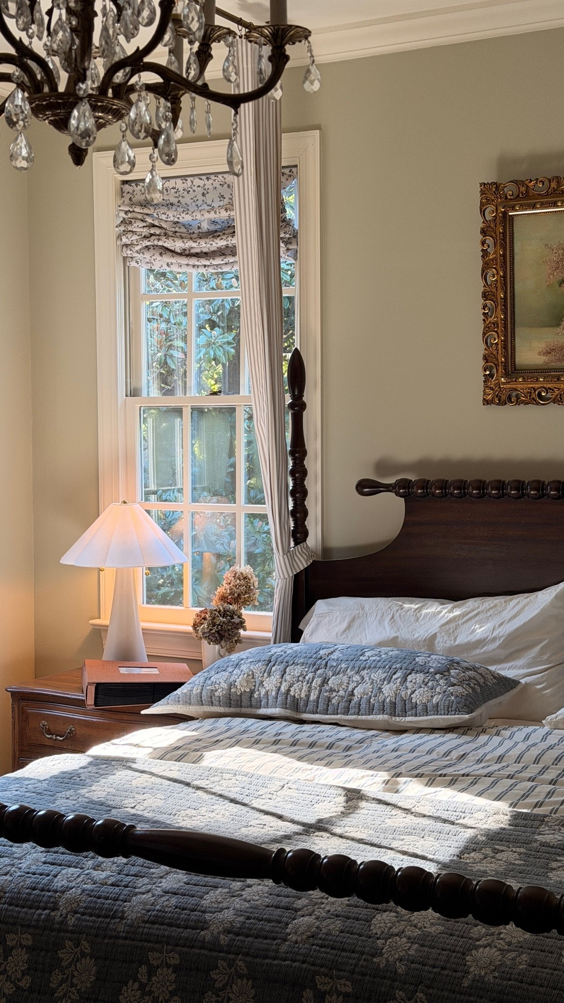 A few favorites from our primary bedroom; the classic blue floral bedding, dark wood bed frame, bedside lamp, floral Roman shades and photo album filled with Summer memories.🤍

#LTKHome