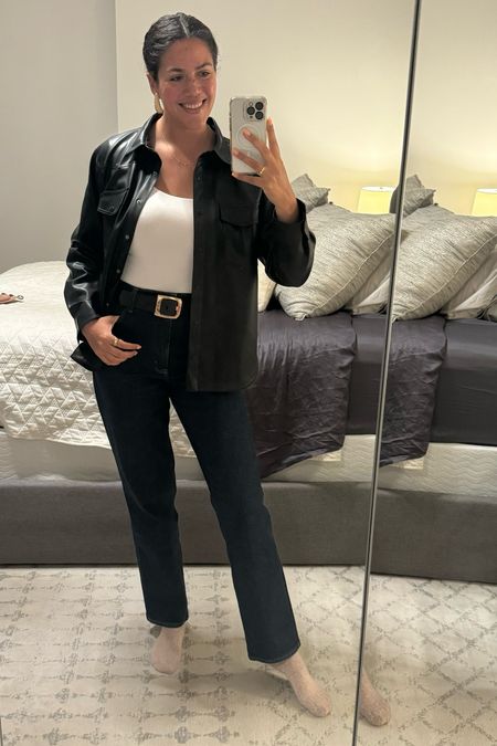 Casual and simple outfit for a chilly winter night! Layered an oversized faux leather shirt jacket (Z supply, size large) over a white scoopneck bodysuit (Mangopop, size large) tucked into dark straight leg jeans (Abercrombie, size 30). A belt with a big gold bucket and statement earrings from Anthropologie complete the look!

#LTKfindsunder100 #LTKmidsize #LTKsalealert