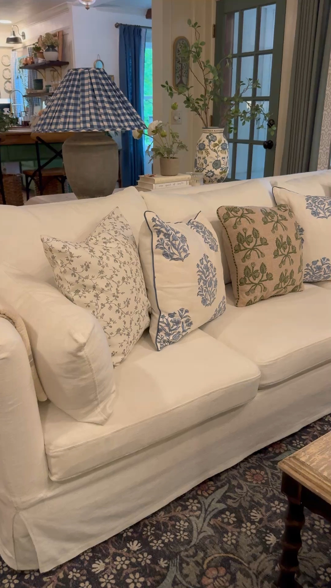 A new pillow combo that I am loving. Added in some extra blue to brighten things up for the spring. Floral pillow covers, blue pillows, green embroidered pillow, custom linen pillow covers, green floral pillows, slipcovered sofa, blue and green ceramic painted vase, artificial greenery stems, realistic greenery. Also linking this gingham pleated lampshade, but it does come with a different base. 

#LTKSeasonal #LTKSaleAlert #LTKHome