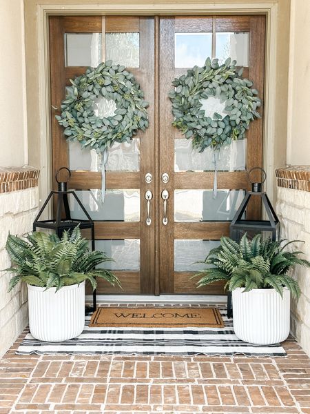 Love my front porch decor! Everything from the front door wreath, the layered front door mats, my viral walmart planters, my oversized lanterns and even the faux ferns! 4/20

#LTKstyletip #LTKfindsunder50 #LTKhome