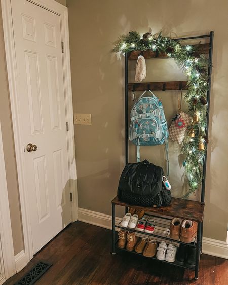 Entry way christmas decor garland idea! I used 2 garlands and twinkle lights. Love using this for the kids stuff! Linked exact diaper bag and backpack too that we use every day. 

Christmas decor. Entryway organization. Mudroom. Easy Christmas decorations. 

#LTKhome #LTKGiftGuide