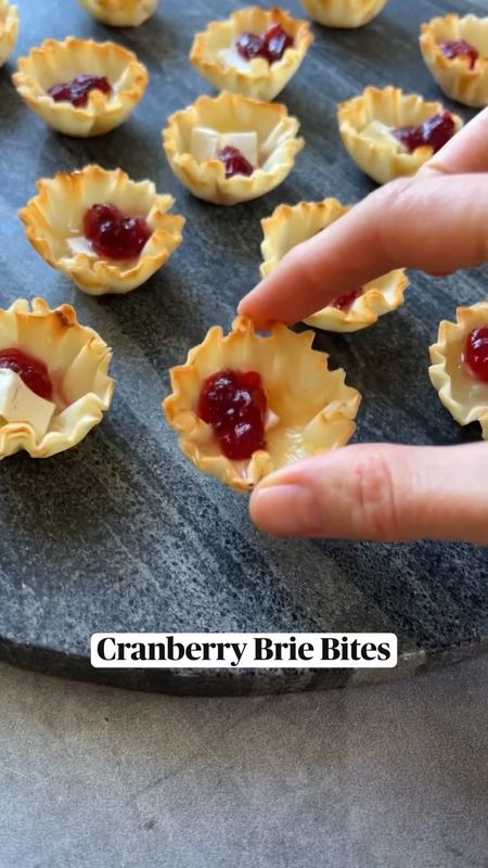 Cranberry Brie Bites
Cranberry brie bites might just be the easiest  appetizer I’ve ever made–all you need is three ingredients, 10 minutes, and some hungry people to please. This is my take on baked brie in puff pastry and let me tell you, these phyllo cups are a game changer. Instead of cutting up pieces of puff pastry and waiting for them to bake, the pre-made phyllo shells put you way ahead of the game. 

1. Preheat the oven to 350°F and line a baking sheet with parchment paper. 
2. Place the phyllo cups on the prepared sheet about 1 inch apart. Add one brie cube to each cup. Bake for 5-8 minutes, or until the cheese is melted and bubbling slightly.
3. Remove from the oven and transfer to a serving platter. Top each cup with about 1 teaspoon cranberry sauce.

#HappyHolidays #Recipe #Pastry #PuffPastry #HolidayParty #Appetizer #Food
https://www.instagram.com/p/Cl4d5pYAo0k/

https://ainttooproudtomeg.com/brie-cranberry-bites-in-phyllo-shells/


#LTKSeasonal #LTKGiftGuide #LTKHoliday