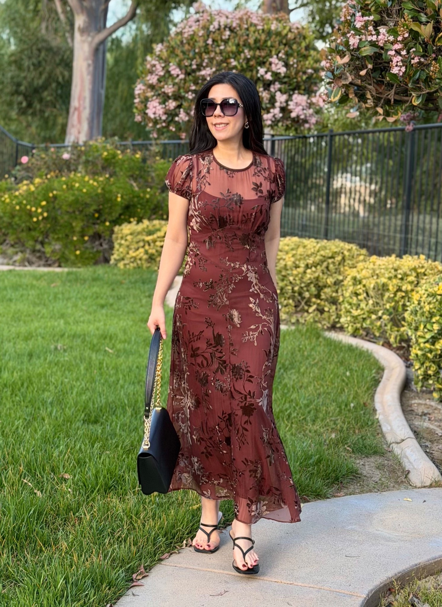 With such busy schedules, it’s hard to carve out some time for a proper date night but we try to do something at least once a month! For the occasion, I wore this chestnut maxi dress that has a slip and sheer overlay on top complete with velvet floral details. I often steer clear of cap sleeves since the cut tends to look unflattering on my arms but the little poof and cinch styling on it somehow makes it look decent! I wore gold earrings along with some simple black strappy heels to complete the look!

#datenight #maxidress #modeststyle #browndress #floraldress 

#LTKootd #LTKWorkwear #LTKPetite