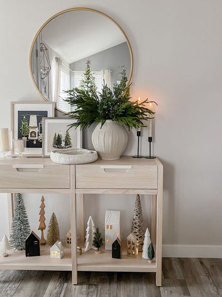 Neutral Christmas village on our console table 🌲





Winter decor, Christmas decor, neutral decor, White House’s, mini houses, Christmas houses, Christmas trees, mini trees, wood console table, winter greenery, pine stems, winter artwork, gold mirror, led candlesticks, black candle holders 

#LTKSeasonal #LTKHoliday #LTKhome