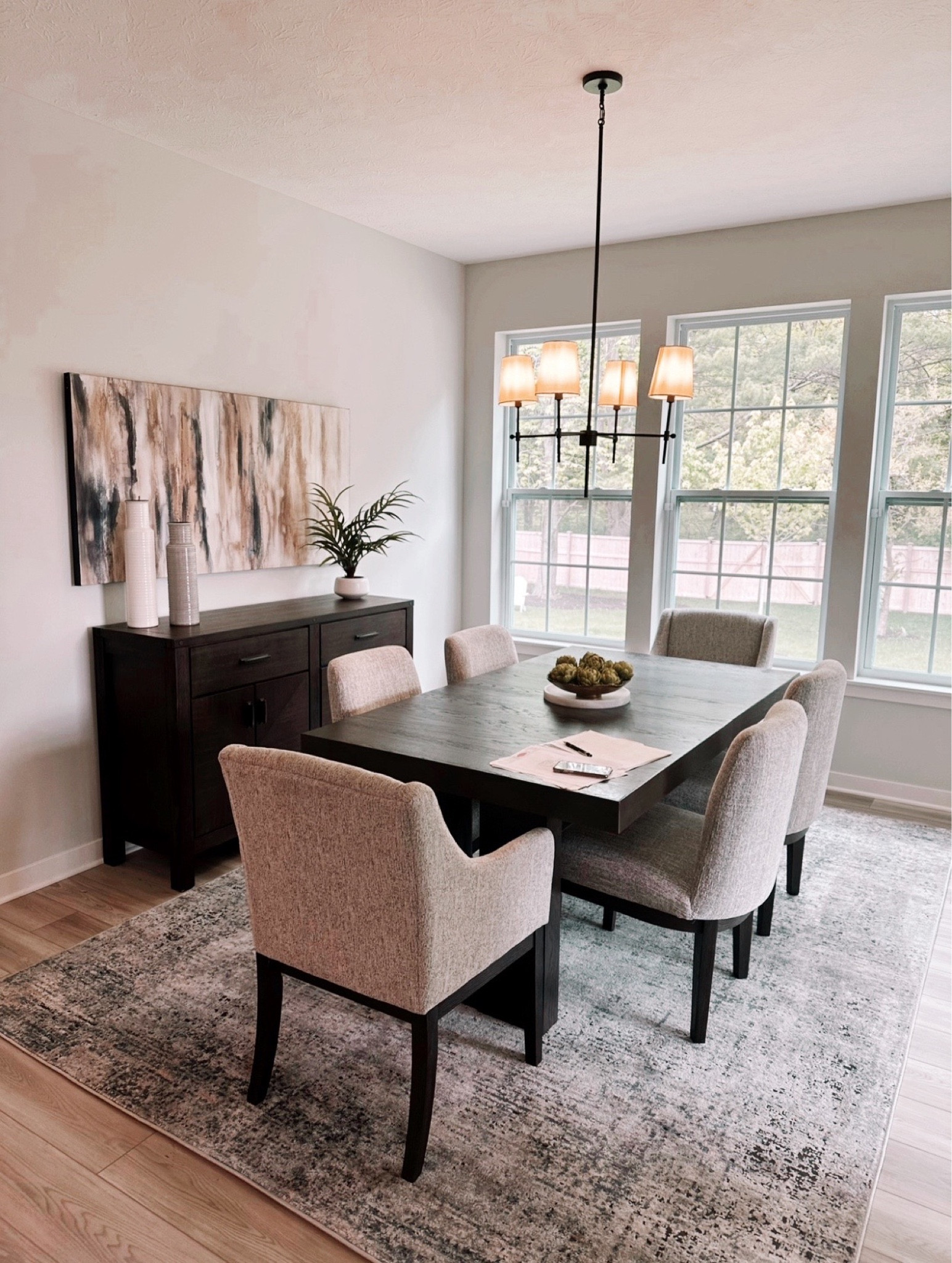 Dressed to thrill, the simply stunning Burkhaus host chair and dining set offers a high-design look at a down-to-earth price. Ultra sleek lines are accentuated with a dark waxy brown oak-tone finish that’s so easy on the eyes. Clean-lined and modern, the double pedestal base and thick edge tabletop showcase quality craftsmanship and attention to detail. Suitably upholstered in a tweed-like neutral fabric, the slope-arm design is tailor-made for comfort. Whether you're hosting family meals or holiday entertaining, it has a timeless look that’s made to last.

#LTKFind #LTKstyletip #LTKhome