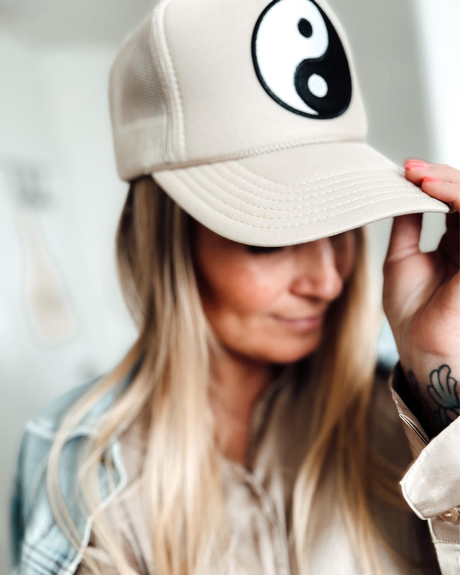 Someone once called me the “hat lady” … she’s not wrong 🫶🏼 I styled my champagne satin button up with a denim jacket and this cute Ascot & Hart hat! #truckerhat #yinandyang 

#LTKunder50 #LTKstyletip #LTKtravel