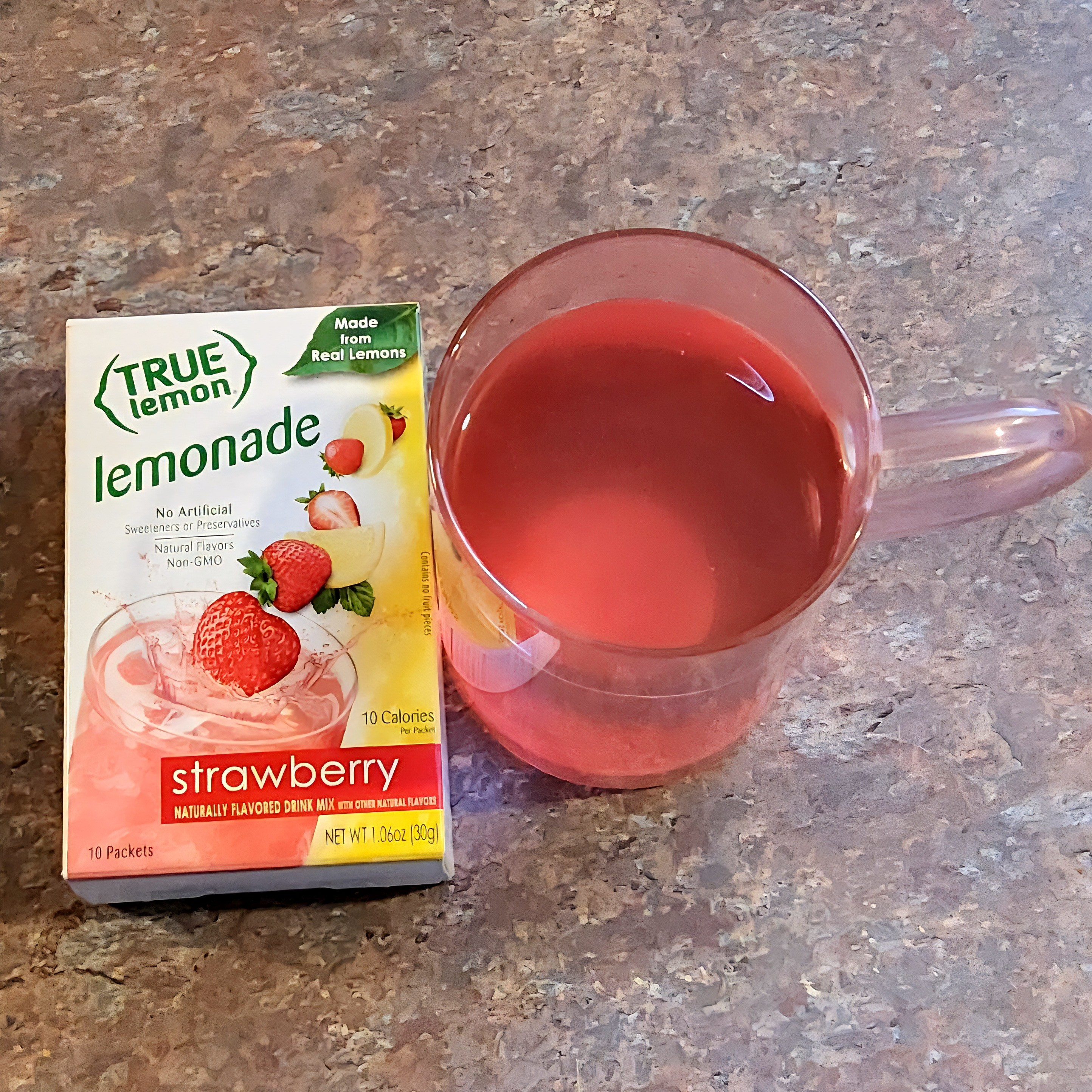 True Lemon Strawberry Lemonade is a refreshing drink. It is vegan and non GMO. It is made from real lemons. Each box has 10 individual powder packets. The powder is easy to mix. It has a slightly sweet and tart taste to it. This drink is tasty and thrist quenching. It's great to take on-the-go too. 

#LTKActive #LTKFamily #LTKU
