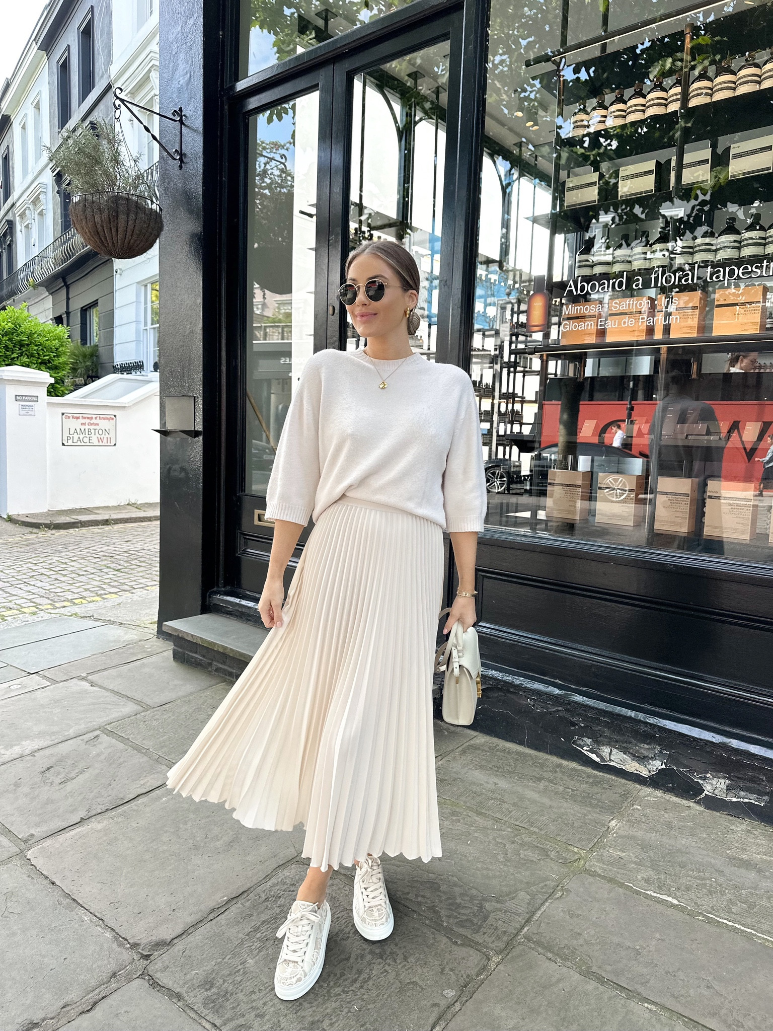 Cream spring outfit idea - fine knit jumper, h&m chiffon pleated skirt, chloe Lauren cream trainers, cream ysl handbag & round rayban sunglasses  

#LTKeurope #LTKSeasonal #LTKstyletip