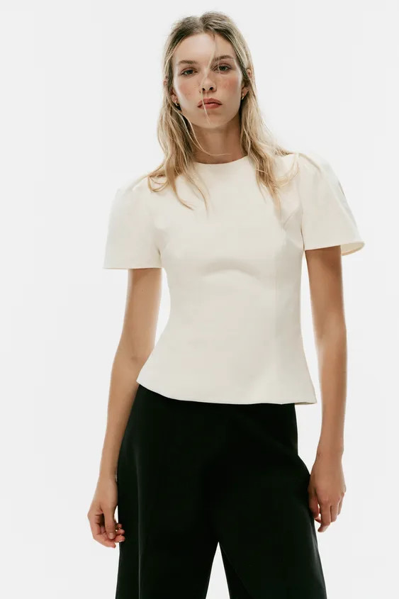 Model height: 176 cmRound neck top with short puff sleeves. Fastens at the back with a concealed ... | Zara UK