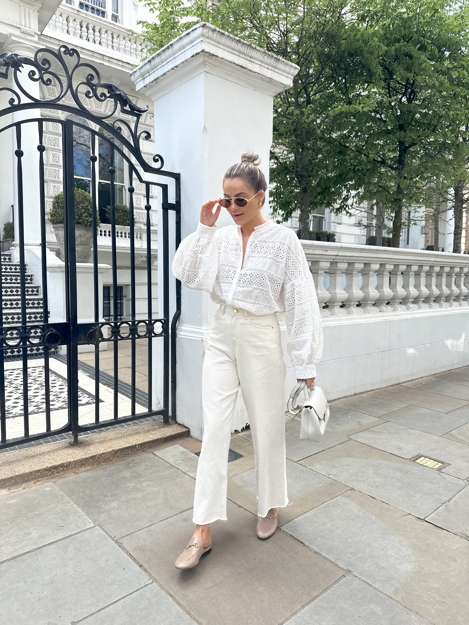 White & cream spring look - maje blouse via farfetch (code 10NADIAANYA for 10% off), cream wide leg jeans, beige Gucci princetown loafers, Bottega sunglasses, gold hoop earrings & polene paris bag (similar linked).

#LTKSeasonal #LTKstyletip #LTKeurope