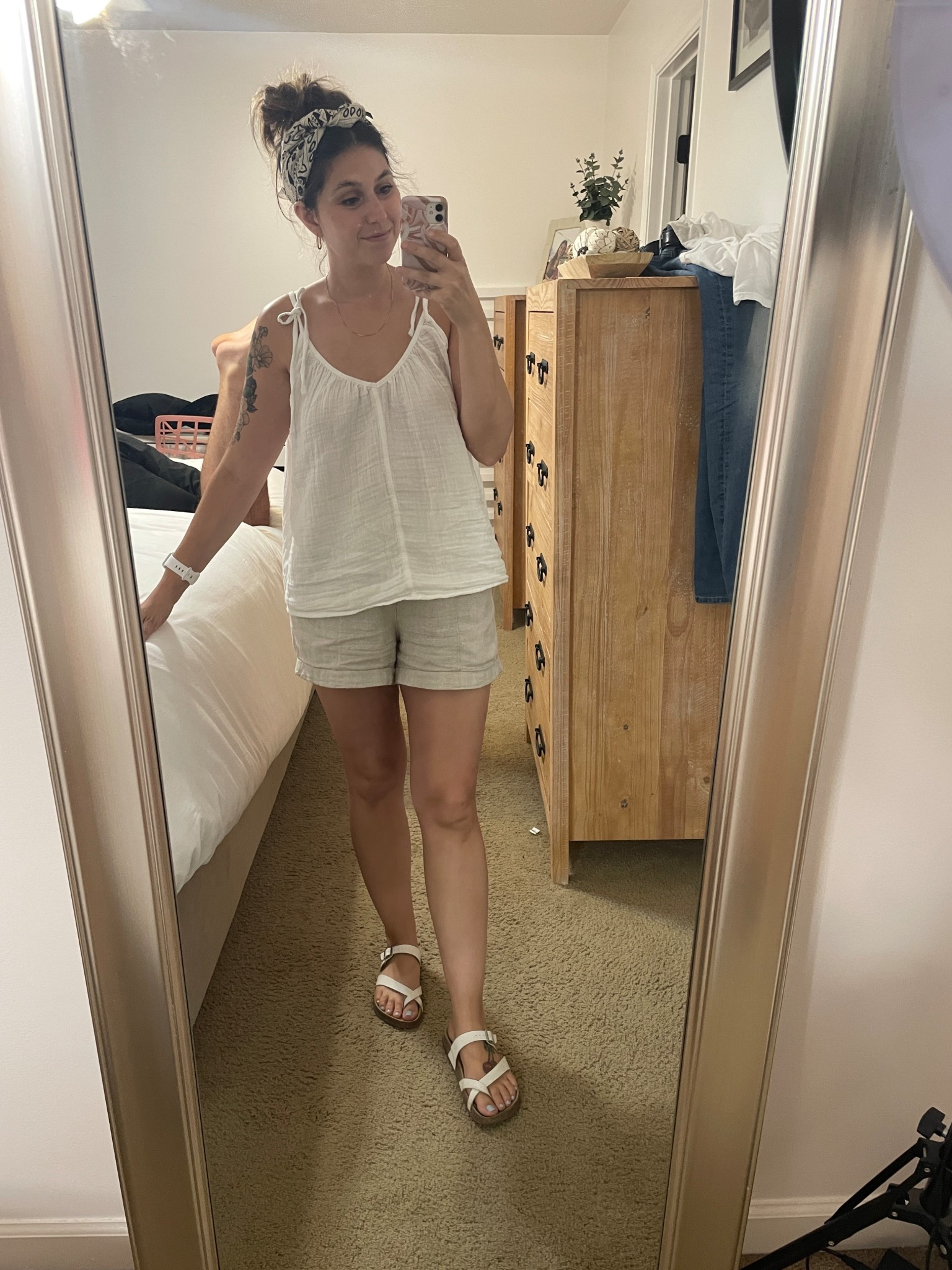 Cute and casual summer outfit, summer outfit for women. I am wearing tan linen shorts from Old Navy in a size small, a white hanging tank top originally from Old Navy but I linked similar ones, white sandals, and a hair scarf from amazon.  #ltksummer #summerfashion #summerstyle25 #summer25 #ltk2025 #oldnavy #amazon #ltkamazon #linen  

 #LTKSummerEdit #LTKSeasonal #LTKFindsUnder50