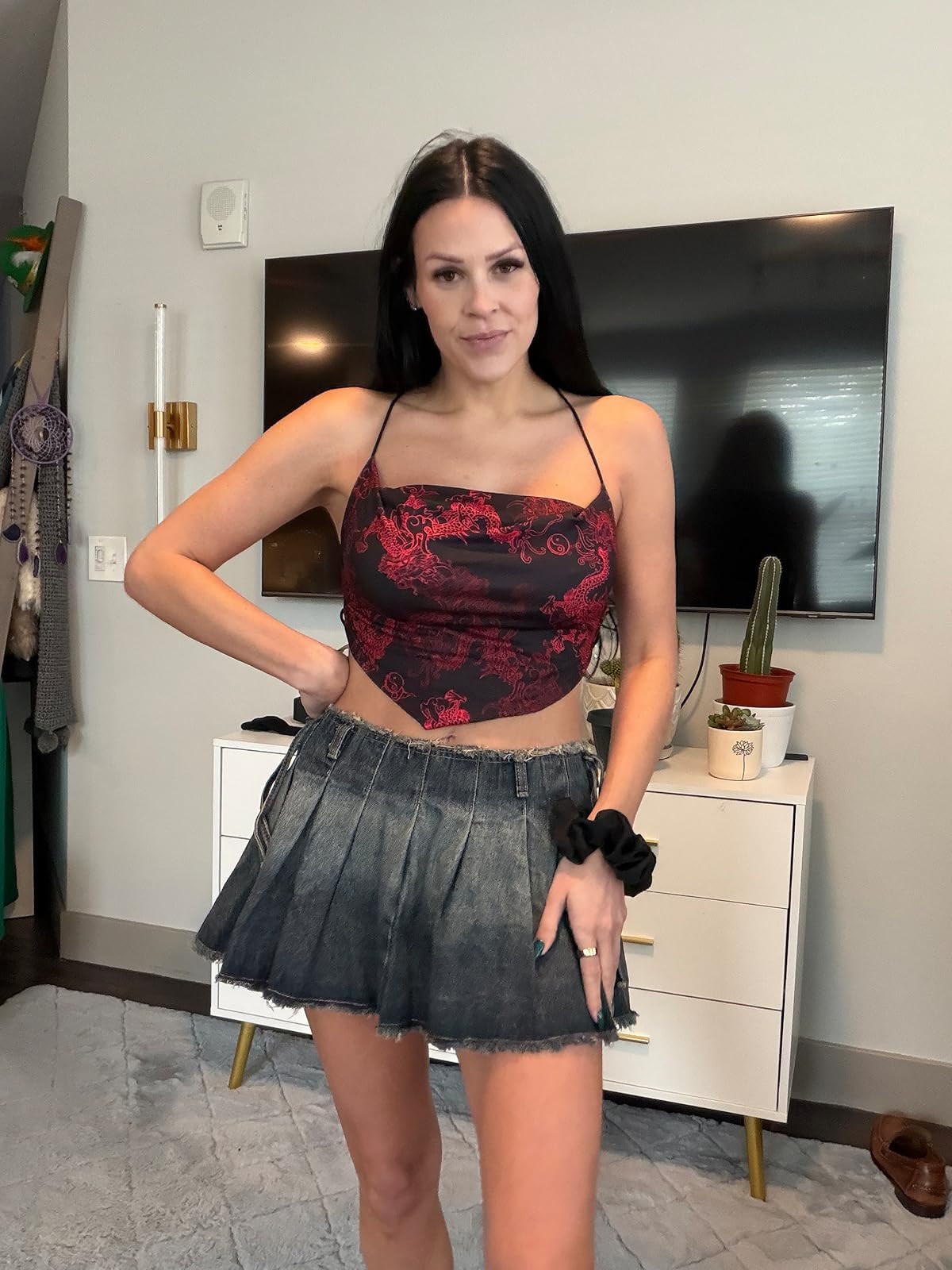 Edgy and bold. This streetwear-inspired look features a red dragon print cowl-neck halter top paired with a pleated dark wash denim mini skirt and a black scrunchie. #DragonPrint #DenimSkirt #LTKstyletip 

 #LTKdayinmylife #LTKgrwm #LTKootd