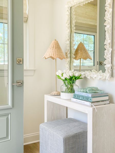 Spring decorating in our entryway! This slim console table is perfect for this right space. I decorated for spring with this scalloped wicker lamp, my favorite faux tulips, my colorblock vase, coastal coffee table books, recycled glass beads, striped ottoman cube and a white coral mirror!
.
#ltkhome #ltkseasonal #ltkunder50 #ltkunder100 #ltkstyletip #ltksalealert entryway decor, spring decorating ideas 

#LTKhome #LTKsalealert #LTKSeasonal
