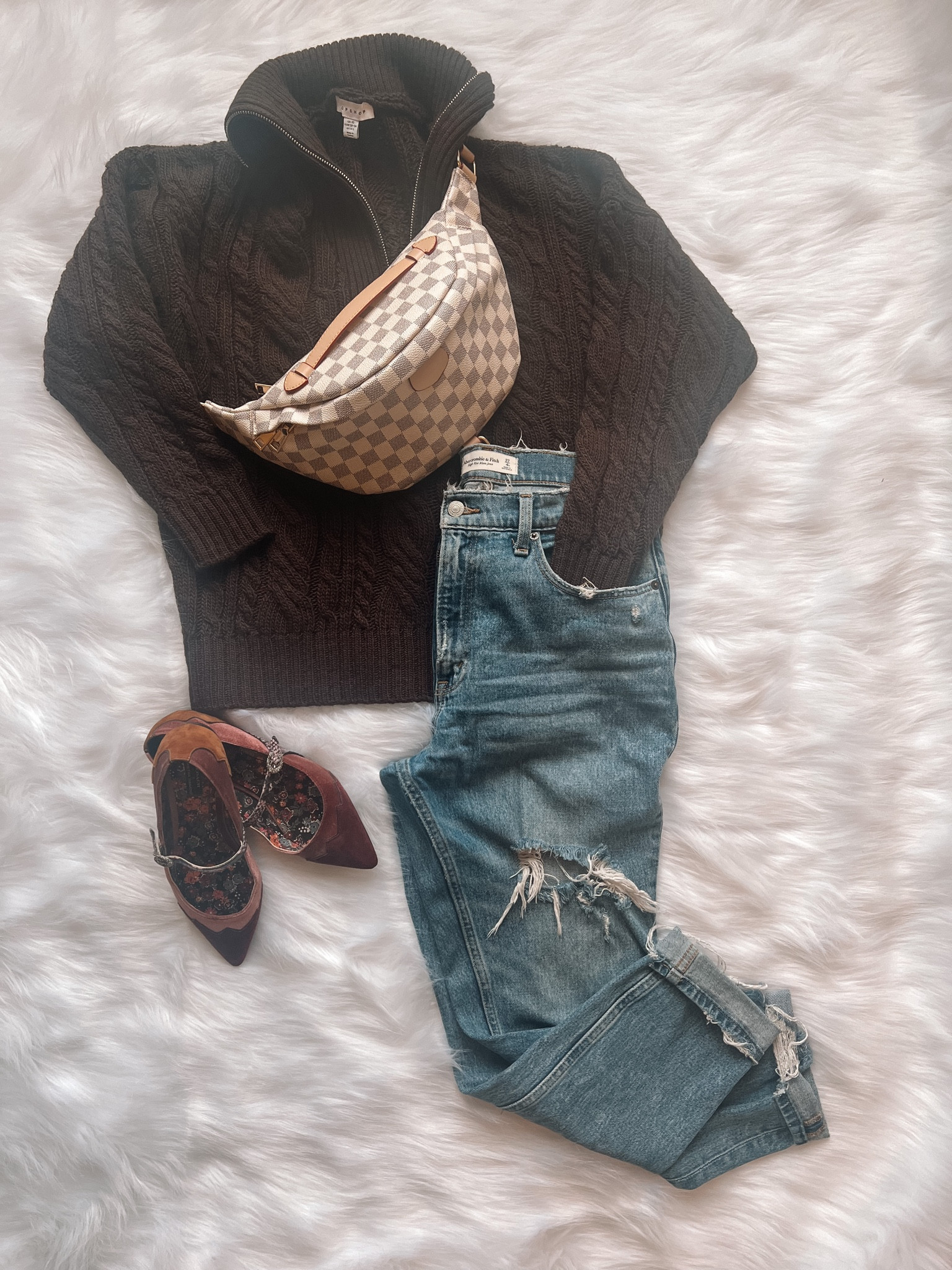 Casual fall styled outfit. Distressed denim jeans, oversized cable knit sweater, color block flats, Louis Vuitton bum bag.

#LTKSeasonal #LTKstyletip