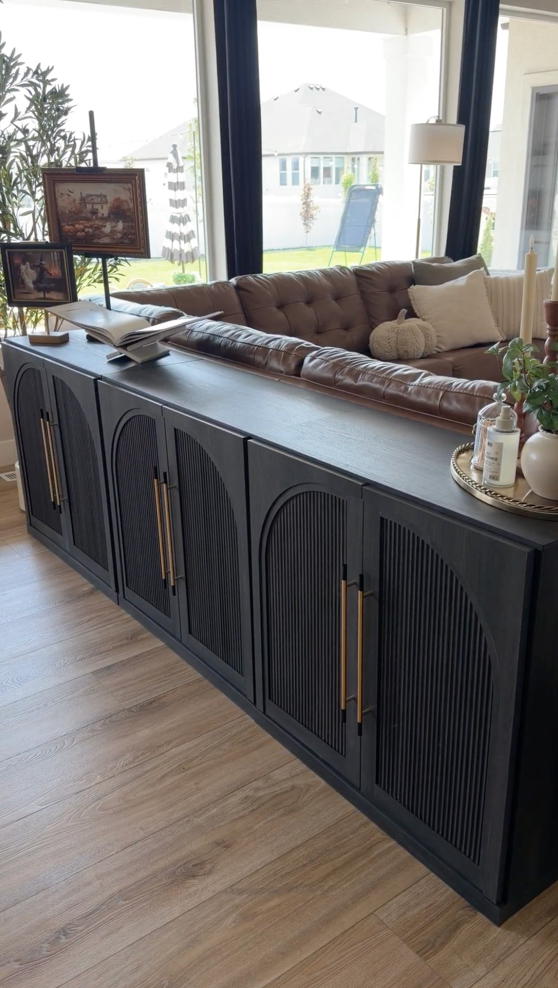 Proof that dog crates can actually look beautiful in your home! These black built-in dog crate cabinets double as a console table while giving your pups their own cozy space. Love the brass hardware and furniture-style design for keeping a living room functional and stylish.

#LTKSeasonal #LTKHome