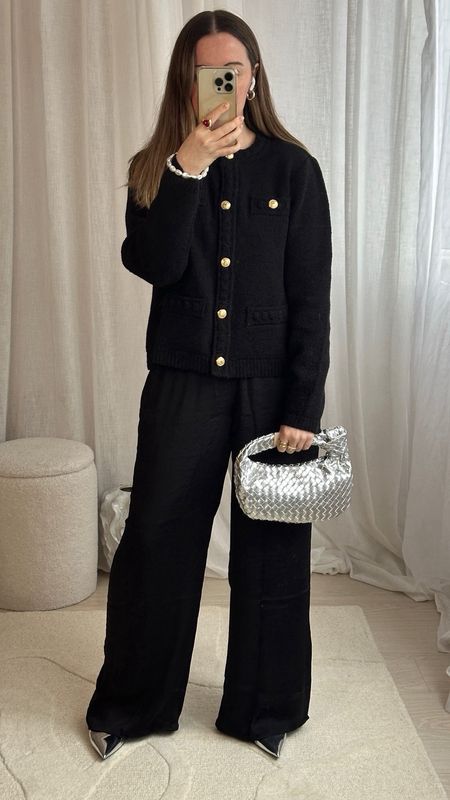 Silver accessories with an all black outfit… such a great classic combo 🖤🪩
Black boucle cardigan | Bottega bag dupe | Designer dupes | Silver bag | Silver shoes | Silk wide legged trousers | January outfit ideas 

#LTKMostLoved #LTKsalealert #LTKU