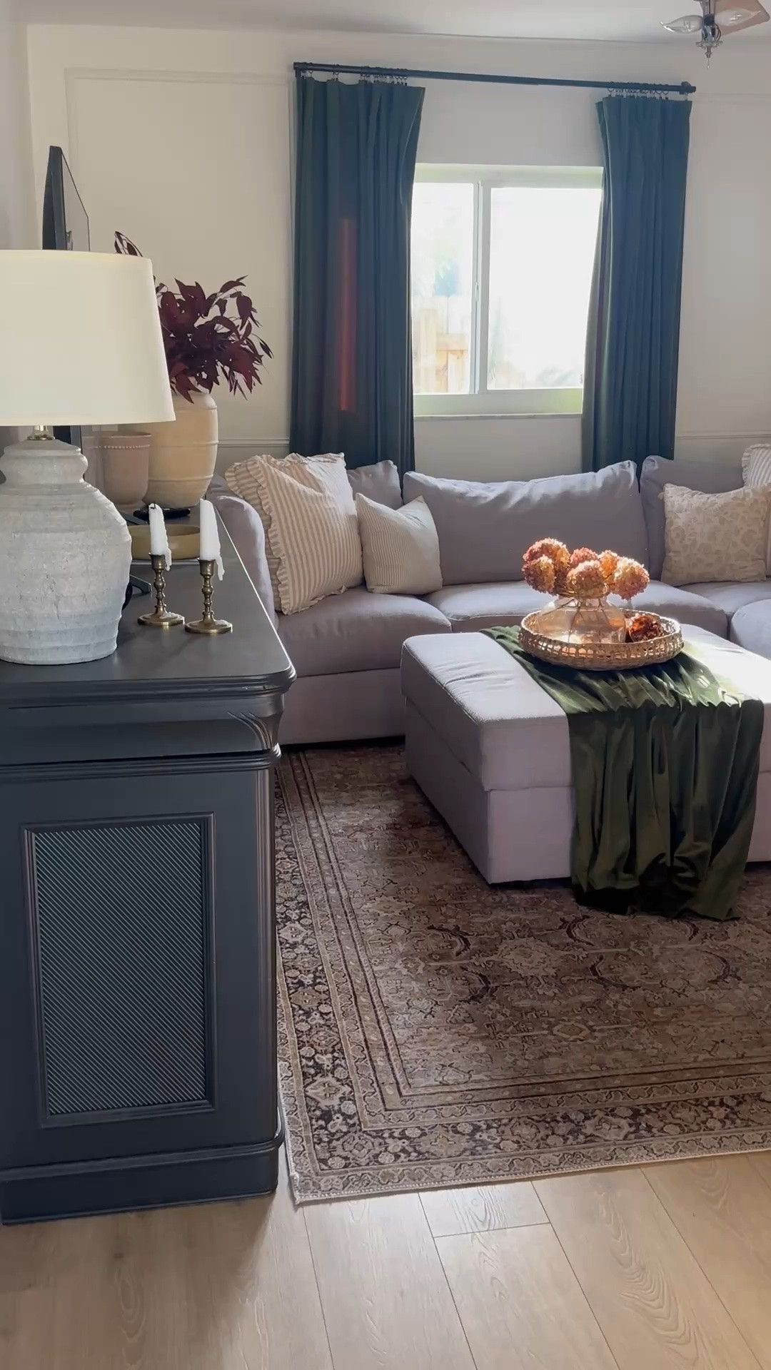 Fall family room cozy layers velvet green curtains, vintage inspired rug, pillows, hydrangeas. 

Living room 
Home decor
Fall decor
Vintage thrifted 
Cottage 
Black cabinet credenza sideboard 
Tv wall
Cozy home
Walmart 
Target
Amazon 
Barn 
Designer look for less
Vintage rug 
Loloi rug 
Moody
Lamp 
Vase 
Candles
Wayfair