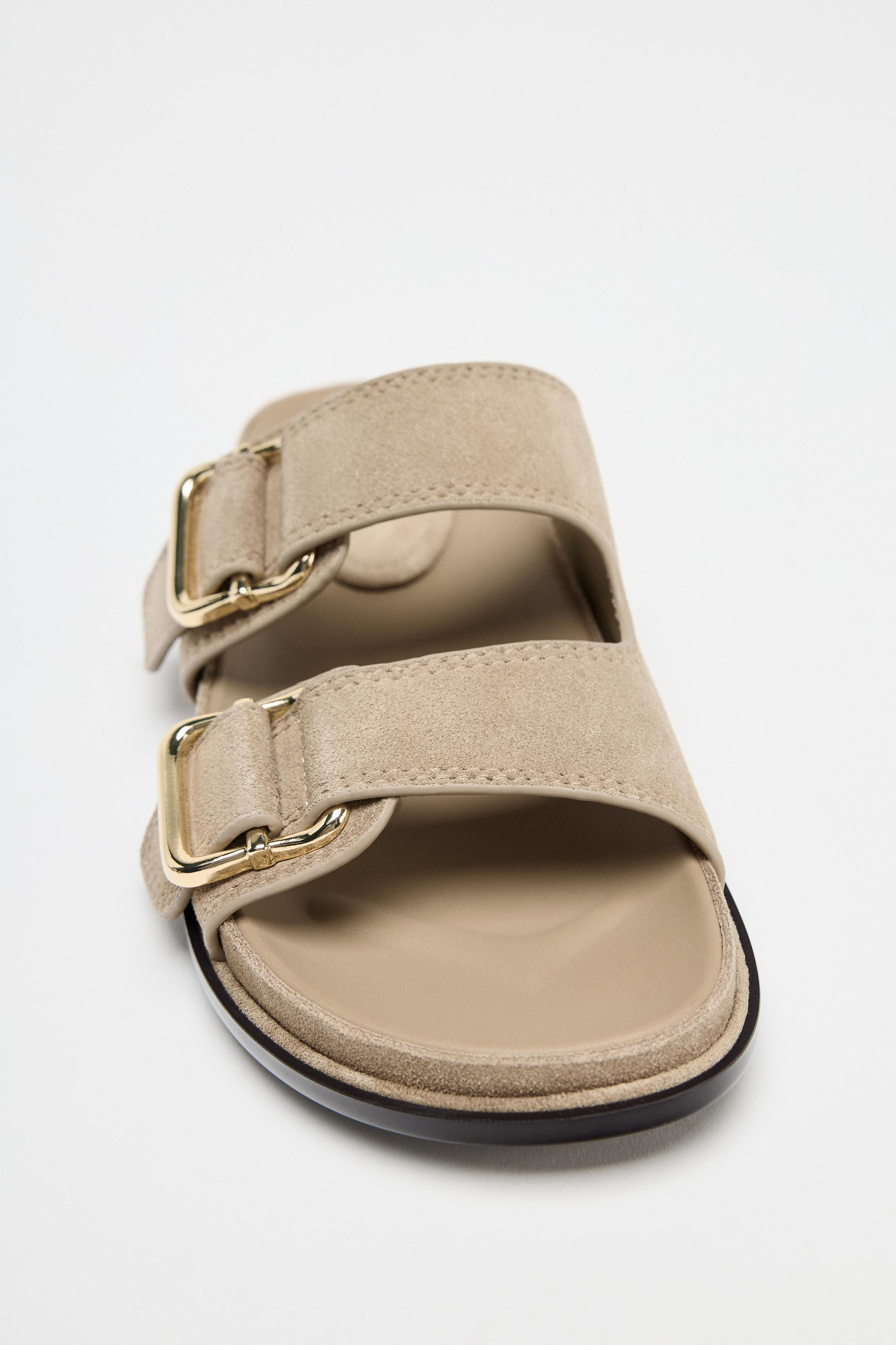 Flat sandal-style shoes in split suede. Double front strap with buckle detail on the front. Round... | Zara UK