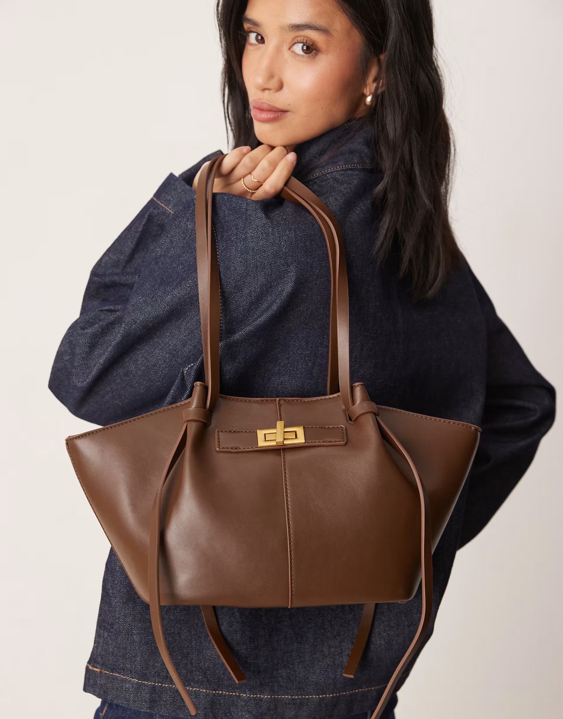 Gina Tricot small faux leather tote bag with strap and clutch detail in dark brown | ASOS (Global)