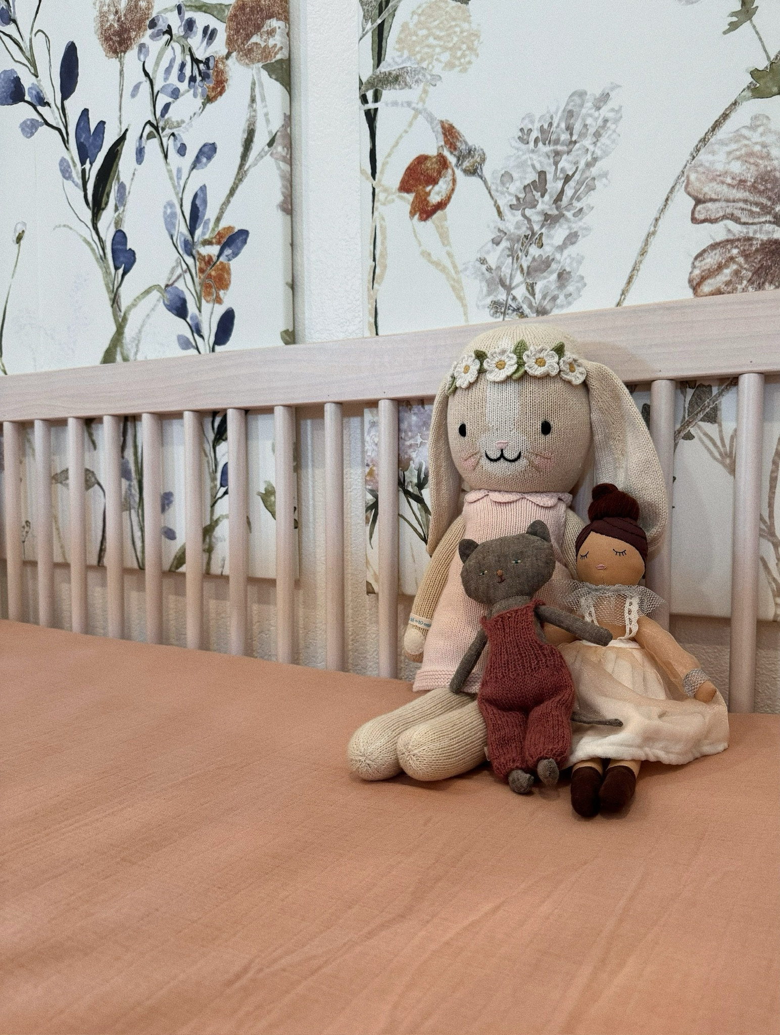 Nursery details🌸🩷 
Love how everything ties together from the crib, sheets and dolls! 
The floral artwork is a DIY project with wallpaper on canvas! (Linked similar) 

baby girl nursery decor 

#LTKBaby #LTKKids #LTKFamily