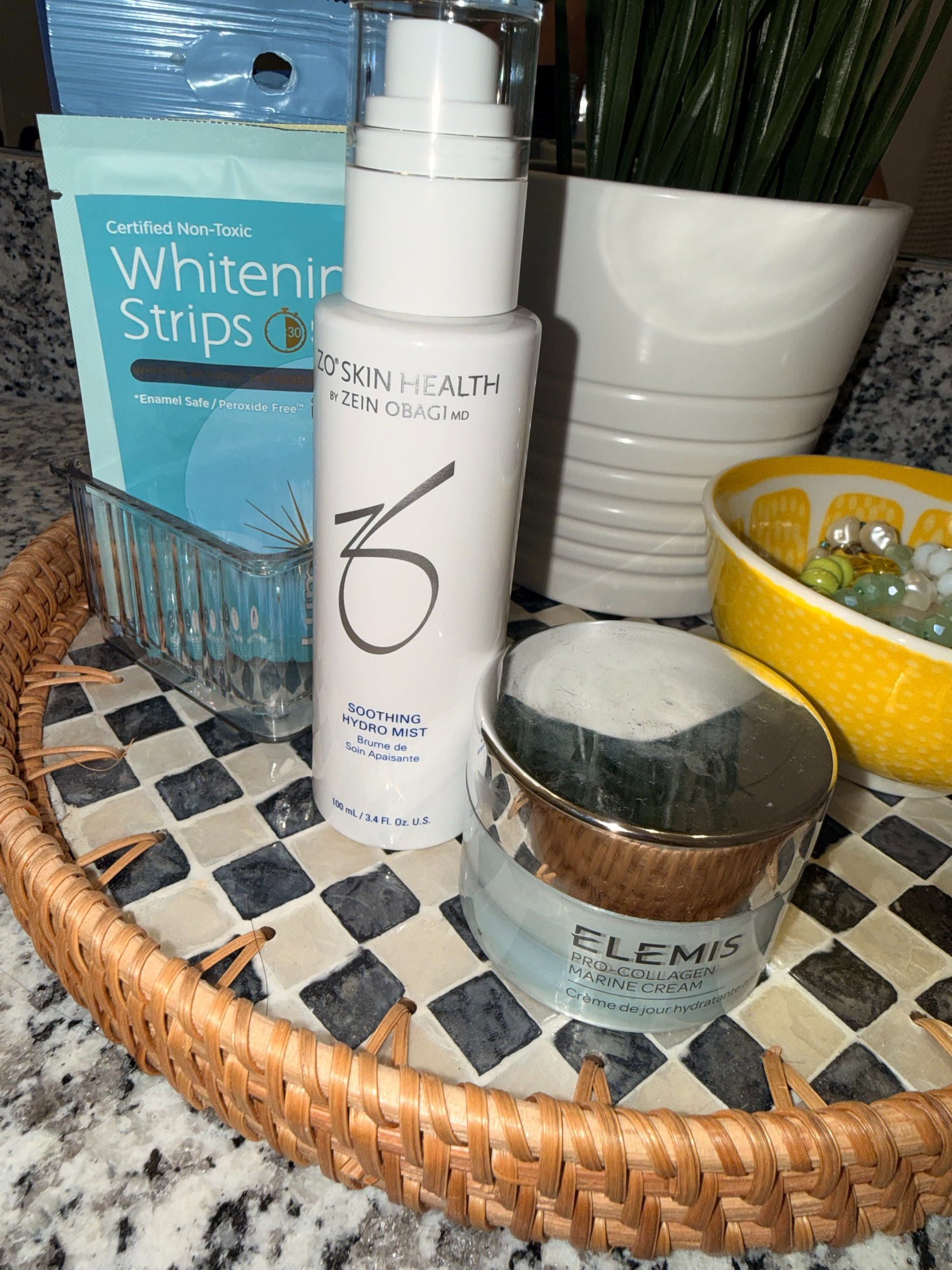 my bathroom counter right now 🤍 the Elemis Pro-Collagen Marine Cream is the richest, dewiest moisturizer (and my skin needs it!!!), plus the ZO Soothing Hydro Mist I'm obsessed with and peroxide-free whitening strips that don't make my teeth sensitive. linked everything + a checkered rattan tray like mine :) #skincareroutine #elemis #zoskinhealth #bathroomdecor #nurseskincare