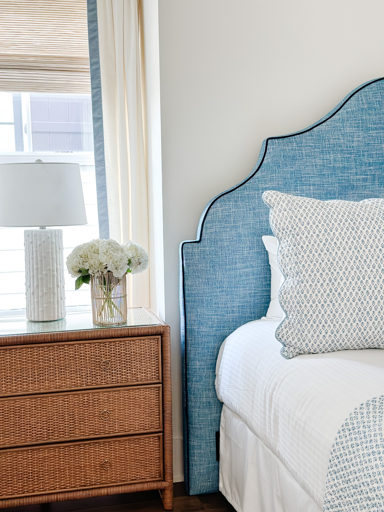Bedroom furniture, coastal bedroom, traditional bedroom, wicker chest, nightstand, wicker, dresser, blue and white, I Amanda Lindroth, batik quilt, Ballard designs, white drapery,, euro sham, woven wood blinds, coastal Interiors 

#LTKhome