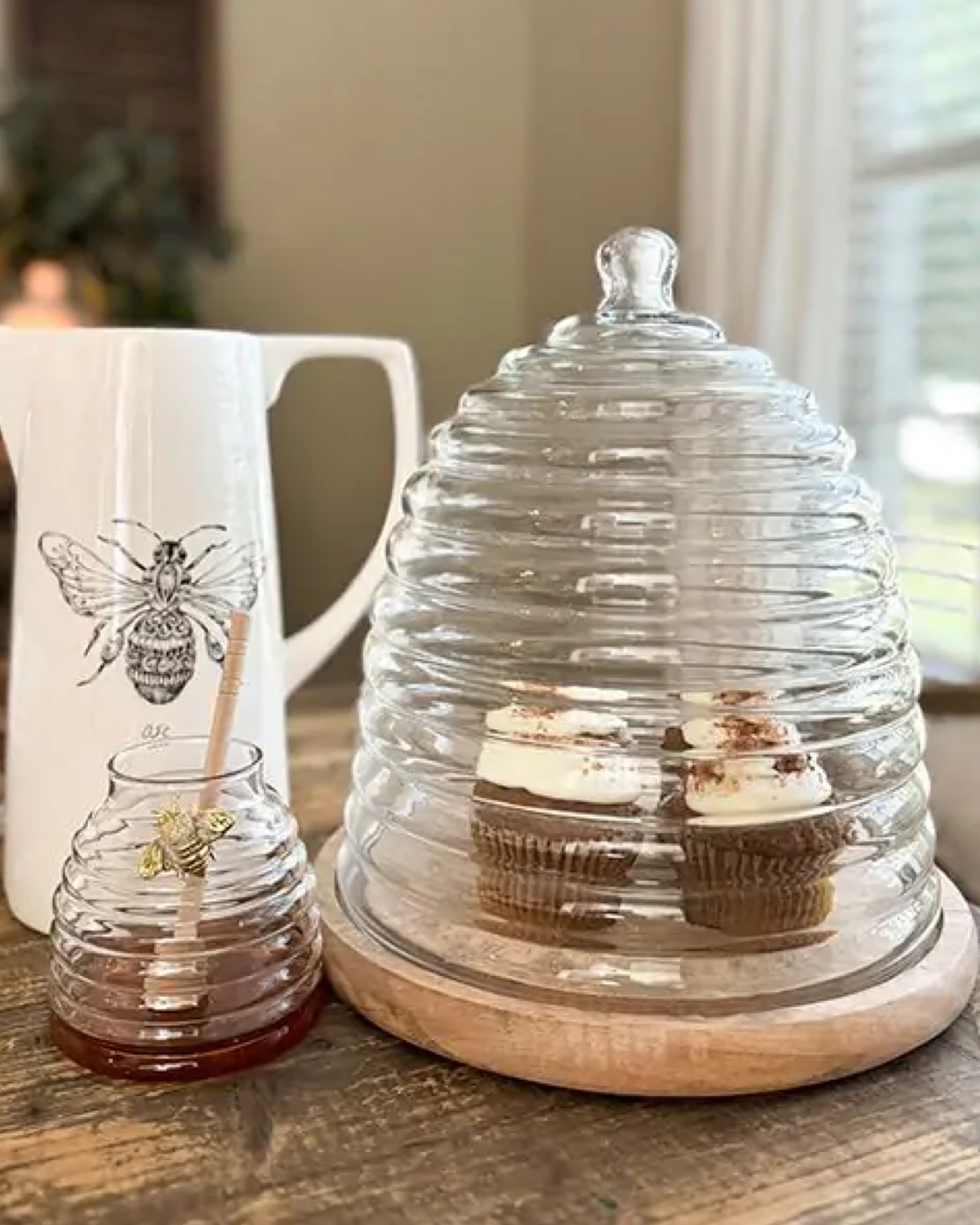 This charming Bee Hive Cloche On Wood Base is crafted from reclaimed glass with a distinctive bee hive shape and a sturdy mango wood base. It’s perfect for parties and covering sweet treats while displayed in the kitchen.

#LTKParties #LTKHome #LTKSeasonal