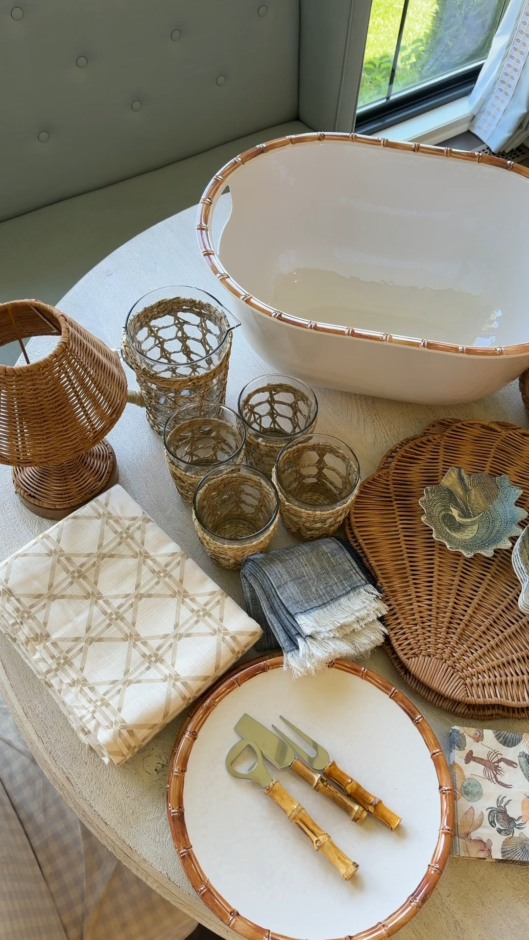 Target Summer Entertaining! 

Coastal dinner 🌊🐚✨
Layered textures, soft blues, and woven details are my go-to for an elevated summer tablescape that still feels effortless. This one is perfect for beach dinners, casual hosting, or even a coastal-inspired everyday table.

I always start with a neutral base, then layer in texture (rattan + wicker), followed by a soft color story—here it’s chambray blue with shell accents for that coastal heirloom feel.

Everything linked to recreate this exact look 🤍

⸻

Product List:

* Neutral geometric tablecloth
* Woven rattan scalloped placemats
* White dinner plates
* Blue chambray fringe napkins
* Decorative shell accents (scallop shells)
* Wicker/rattan napkin rings (optional styling layer)
* Mixed glassware:
    * Stemless wine glasses
    * Stemmed wine glasses
    * Textured water glasses
* Woven glass votive holders
* Glass serving bowl (organic shape)
* Rattan table lamp (statement centerpiece)
* Wicker bread basket
* Coastal shell décor accents

⸻

Hashtags:

#LTKhome #LTKfinds #LTKsummer
#grandmillennialstyle #coastaldecor #coastaltablescape
#traditionalhome #classicstyle #southernstyle
#entertainingathome #hostesswiththemostess
#summerentertaining #tablescapestyling
#blueandwhitedecor #wovenhome #rattanstyle
#elevatedeveryday #heirloomstyle