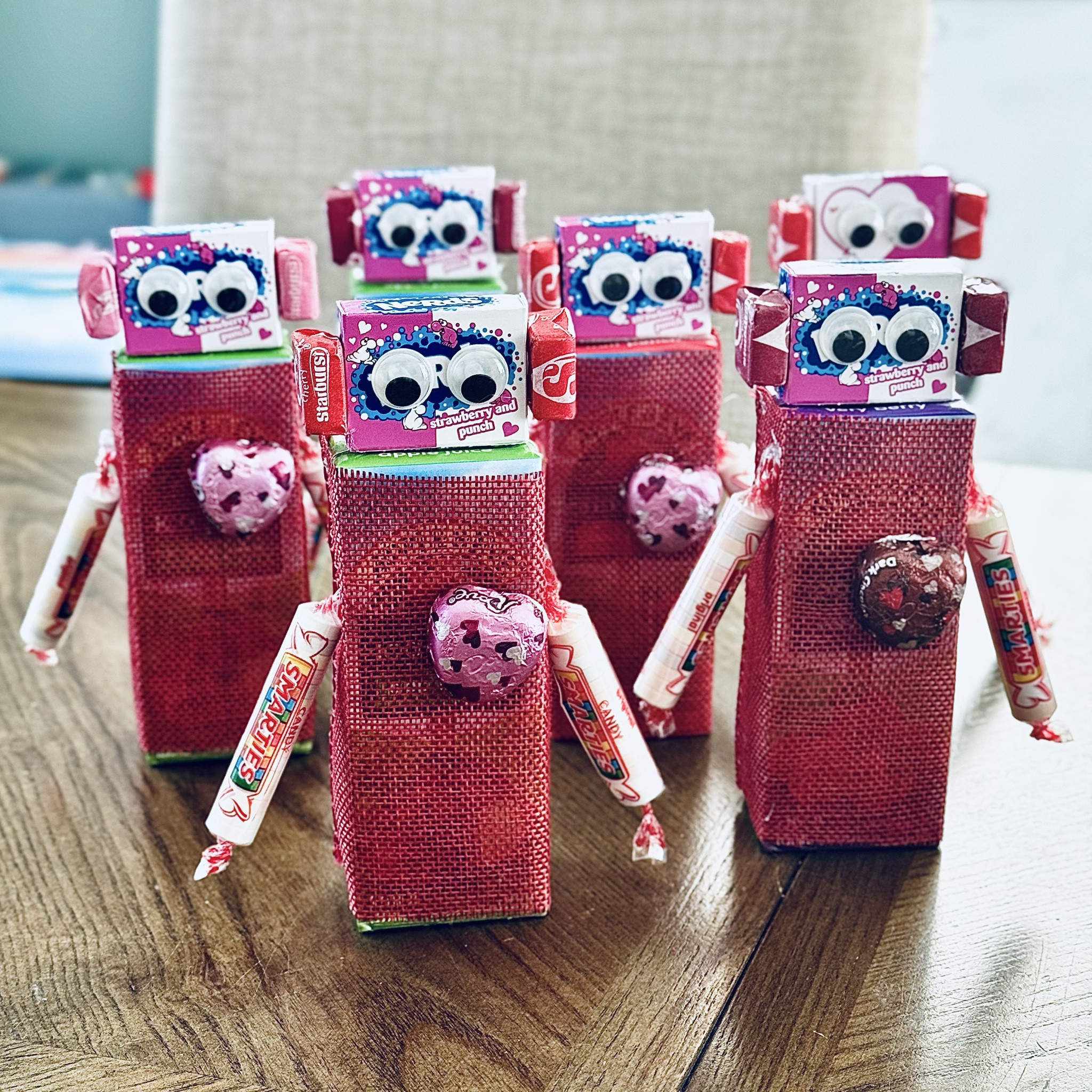 These little DIY Love Bot 🤖 juice boxes are ready to make any classroom party extra fun 💕 Perfect for Valentine’s Day, class celebrations, or parties — and seriously so easy to make. All you need are juice boxes, ribbon (or construction paper… or nothing at all!), a little hot glue or glue dots, Smarties for arms, a chocolate heart, Nerds boxes + Starburst for ears, and googly eyes to bring them to life. I wrapped the ribbon halfway so the straw stays exposed in the back for easy sipping. Easy, cute, and kid-approved!

#LTKKids #LTKSeasonal #LTKmomlife