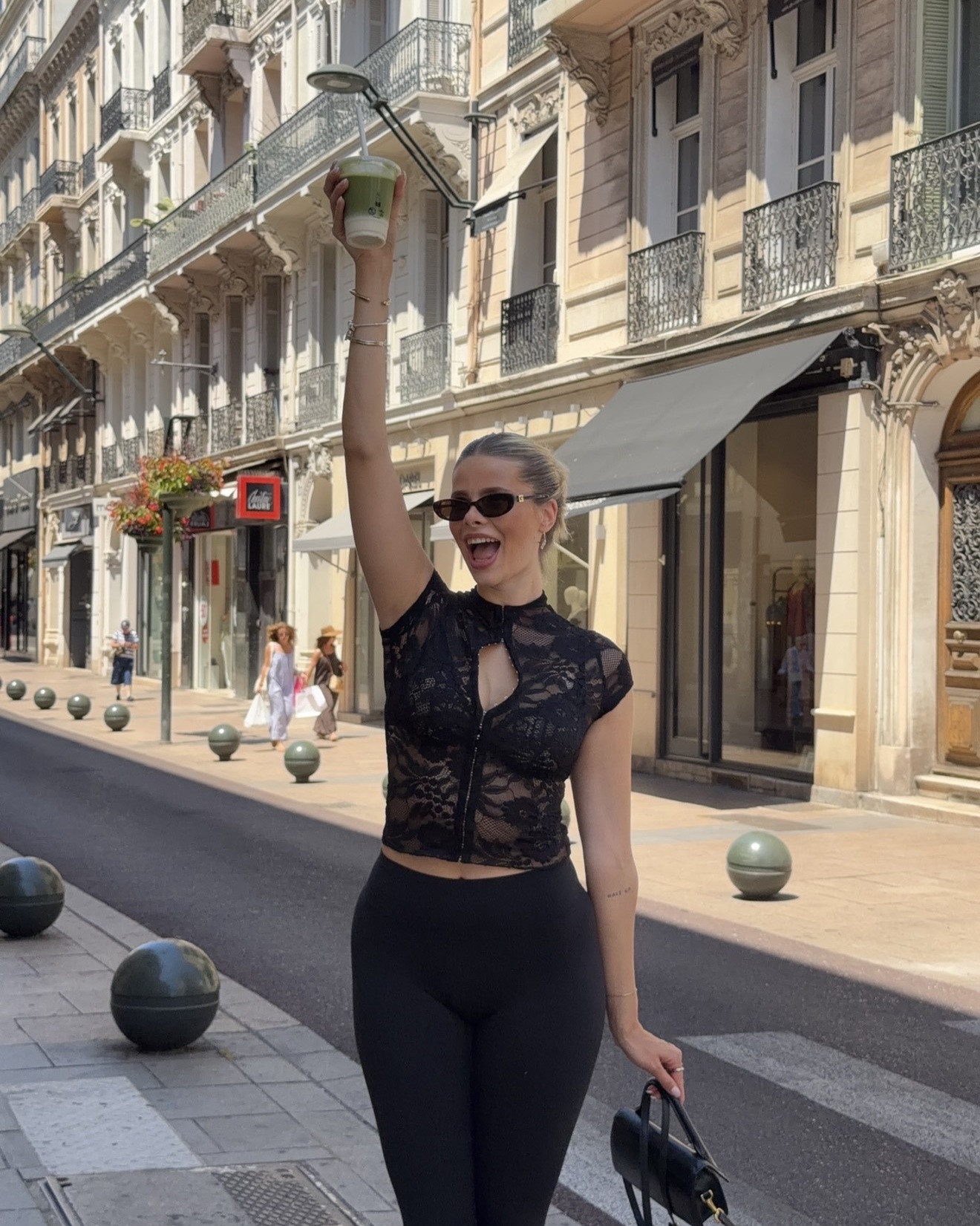 The ultimate European summer outfit for exploring the city in style. This chic all-black look features a black lace top, capri leggings, sleek sunglasses, a mini black handbag, and an iced matcha for the perfect café moment.

#LTKFashionMonth #LTKsummer