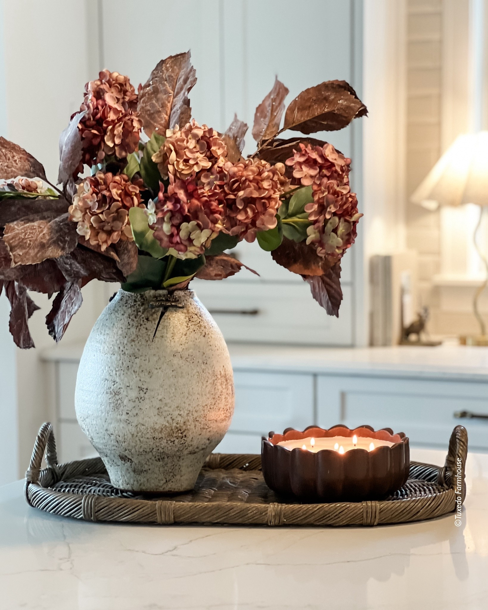 Moody florals, a unique vase and a pretty candle. Put it all on a fun tray and your counter styling is done. 

#LTKHome #LTKSeasonal #LTKFindsUnder50
