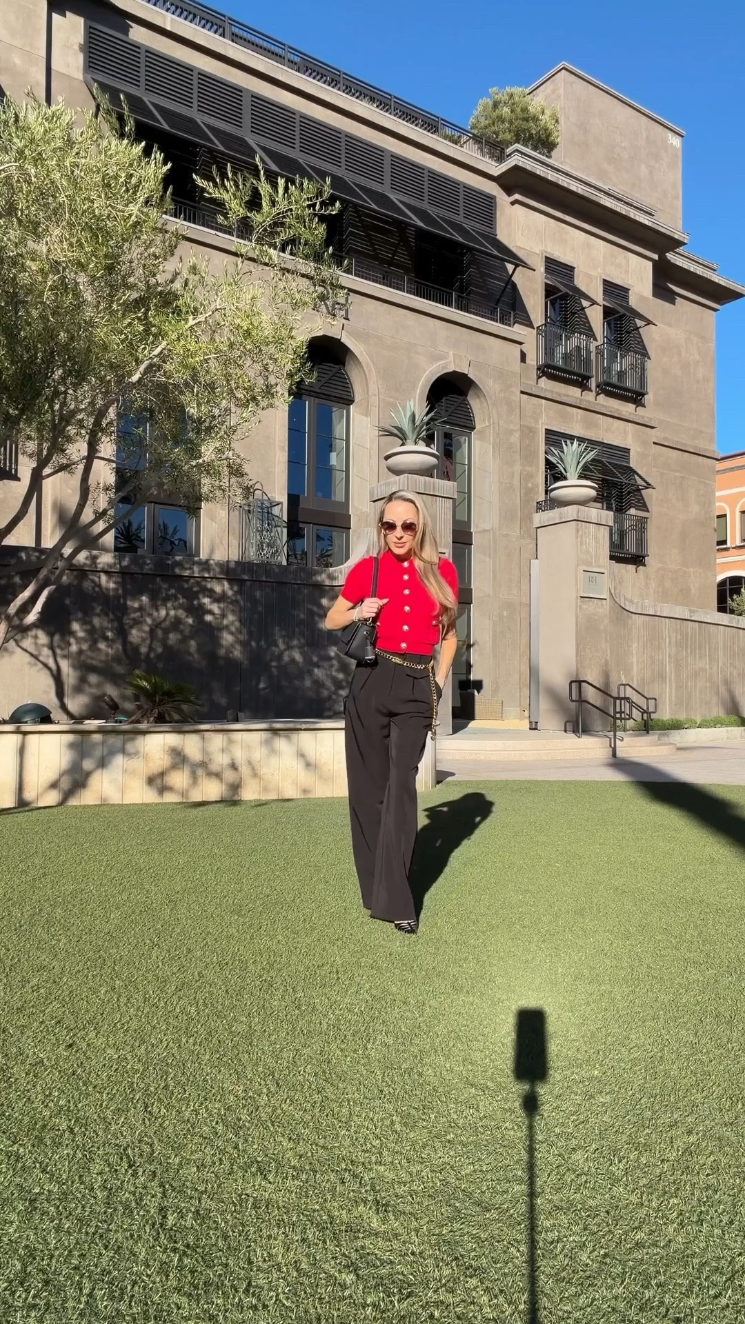 OOTD Fall outfit inspo: black high waisted pants, gold chain Chanel belt, red sweater with gold buttons, Christian Louboutin heels, Quay sunglasses from their limited-edition holiday collection (oval crafted with delicate metal work and embellished pearly details), and a black leather shoulder bag for the day and gold crystal Dior bag for the evening. 

#LTKWorkwear #LTKStyleTip #LTKSeasonal