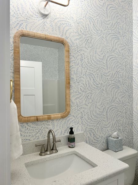 Beach bathroom with rattan mirror and Serena and Lily wallpaper 