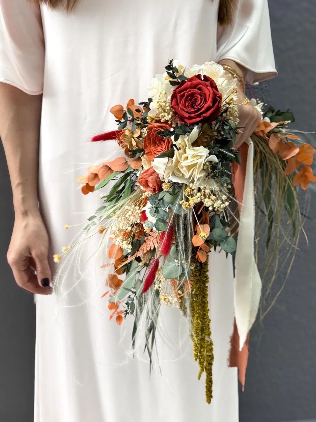 This elegant hoop-style bridal bouquet features preserved roses, eucalyptus, amaranthus, ozothamnus, fern, mountain flowers, and soft bunny tails for a romantic boho look. The crescent handle design creates a modern, airy silhouette that’s perfect for brides or bridesmaids who love natural textures and earthy tones. Made with real preserved blooms, this handmade arrangement doubles as a beautiful keepsake long after the wedding day. #ltkbride #ltkhome #bohowedding #bridalbouquet #weddinginspiration #preservedflowers #driedflowers #rusticwedding #bohobride #weddingdetails

#LTKSeasonal #LTKWedding #LTKHome