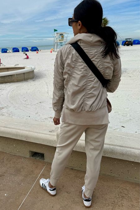 Travel outfit. Spring outfit. Spring jacket. Bomber jacket. Athleisure. True to size. 
Joggers with slim fit; i sized down. 
Sneakers. 
Belt bag. 
Sunglasses  

#LTKfitness #LTKtravel #LTKsalealert