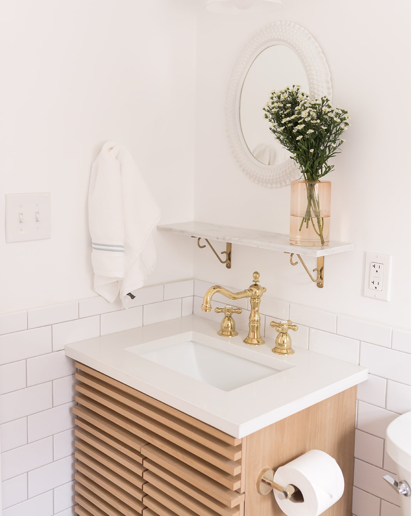 because the tile and tub serve as such bold design elements in this small bathroom space, we kept things simple with the vanity at the #mixedusemini. a minimal white oak vanity occupies the corner of the room and is topped with durable white quartz. we also added a small marble shelf for extra storage. a vintage milk glass-style oval mirror, conical sconce, and brass faucet complete the space. #dwelloctoberstay #dwelloctober

#LTKHome
