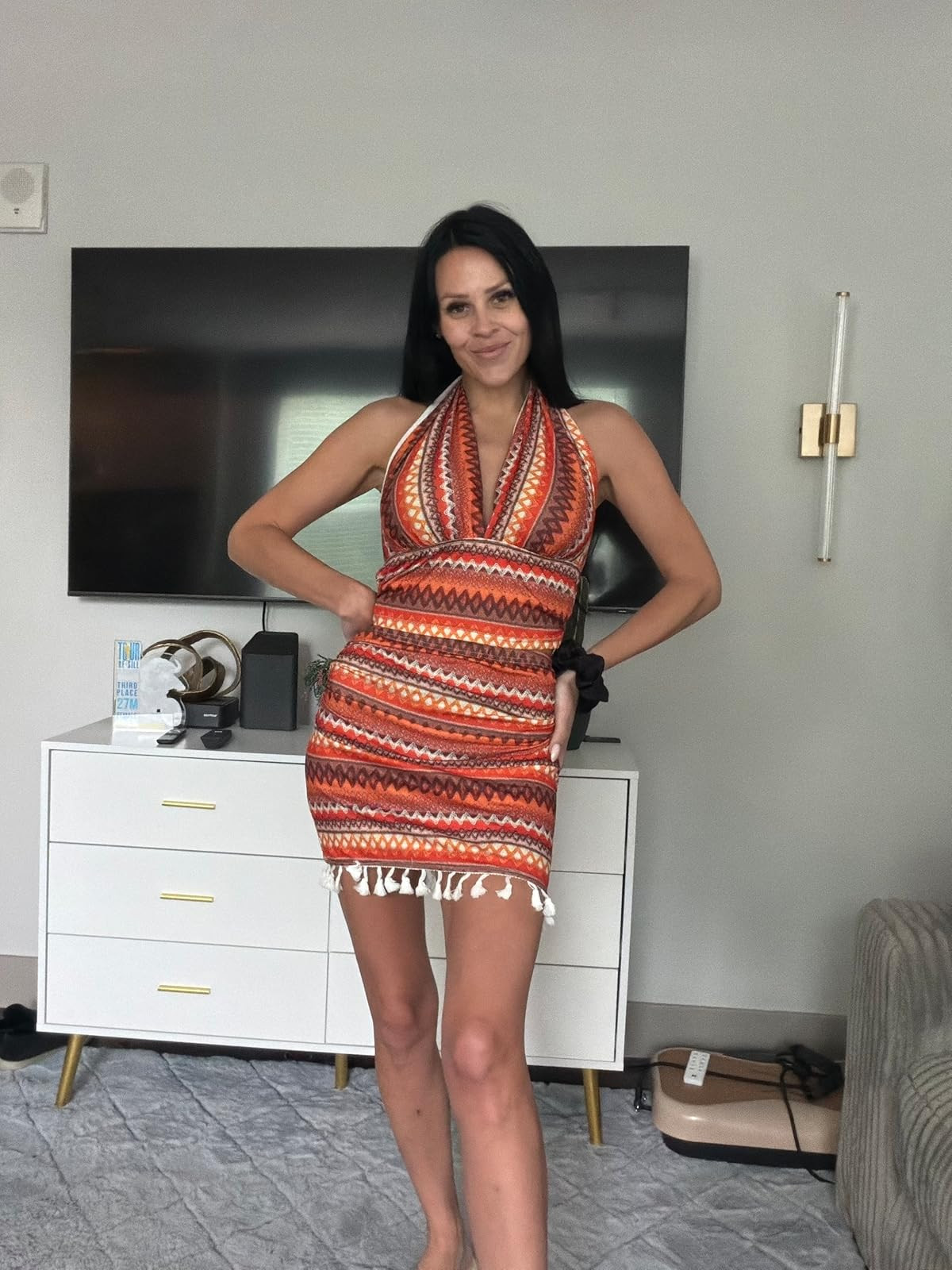 Obsessed with the retro boho vibes of this halter mini dress! The warm geometric print and playful fringe detail make it the perfect outfit for your next vacation or a sunny day out. Shop my exact look by clicking the link in my bio! #LTKunder50 #VacationStyle #BohoChic 

 #LTKdayinmylife #LTKgrwm #LTKootd